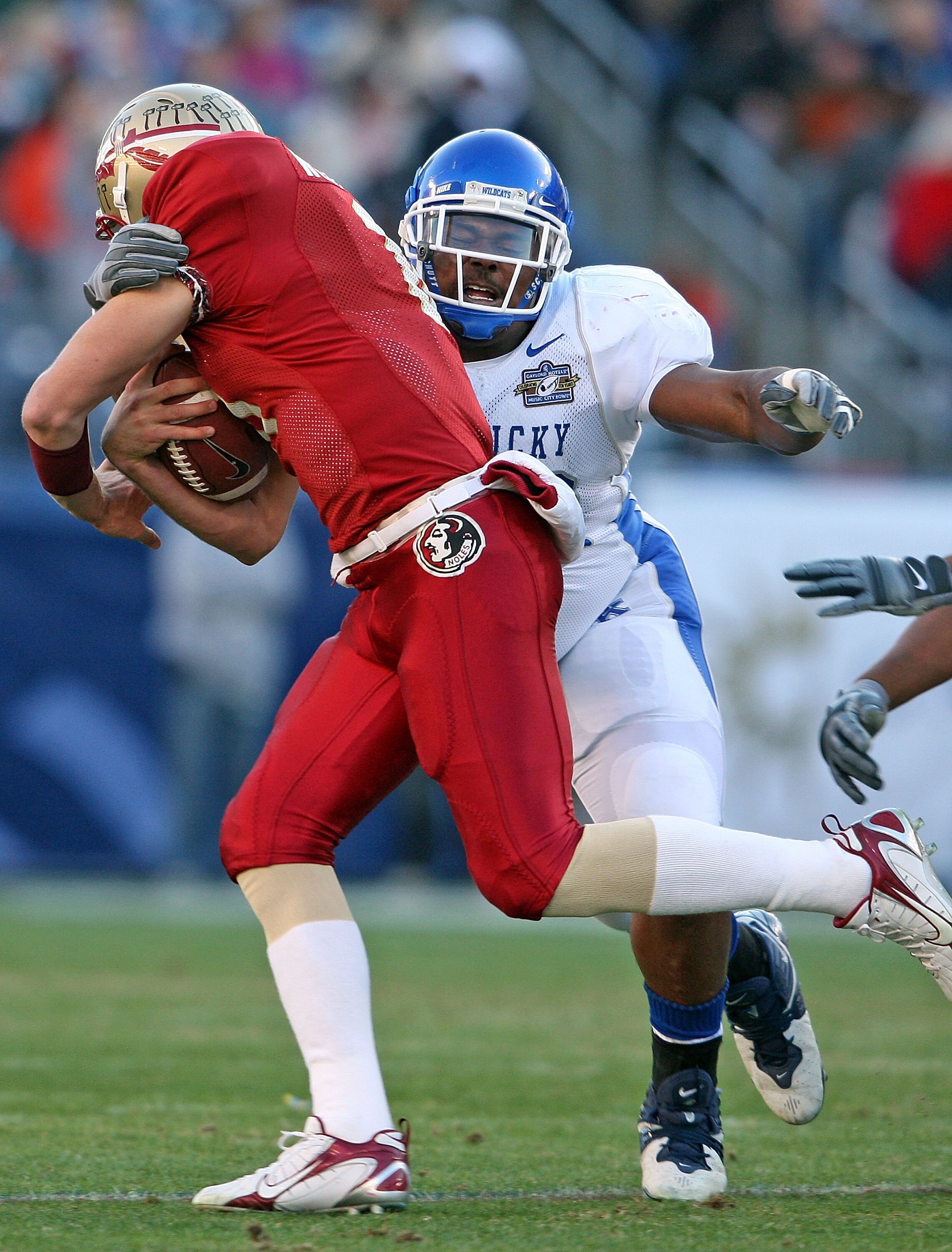 NASHVILLE, TN - DECEMBER 31:  Myron Pryor #98 of the Kentucky Wildcats tackles Drew Weatherford #11 of the Florida State Seminoles during the Gaylord Hotels Music City Bowl at the LP Field December 31, 2007 in Nashville, Tennessee. Kentucky won 35-28.  (P
