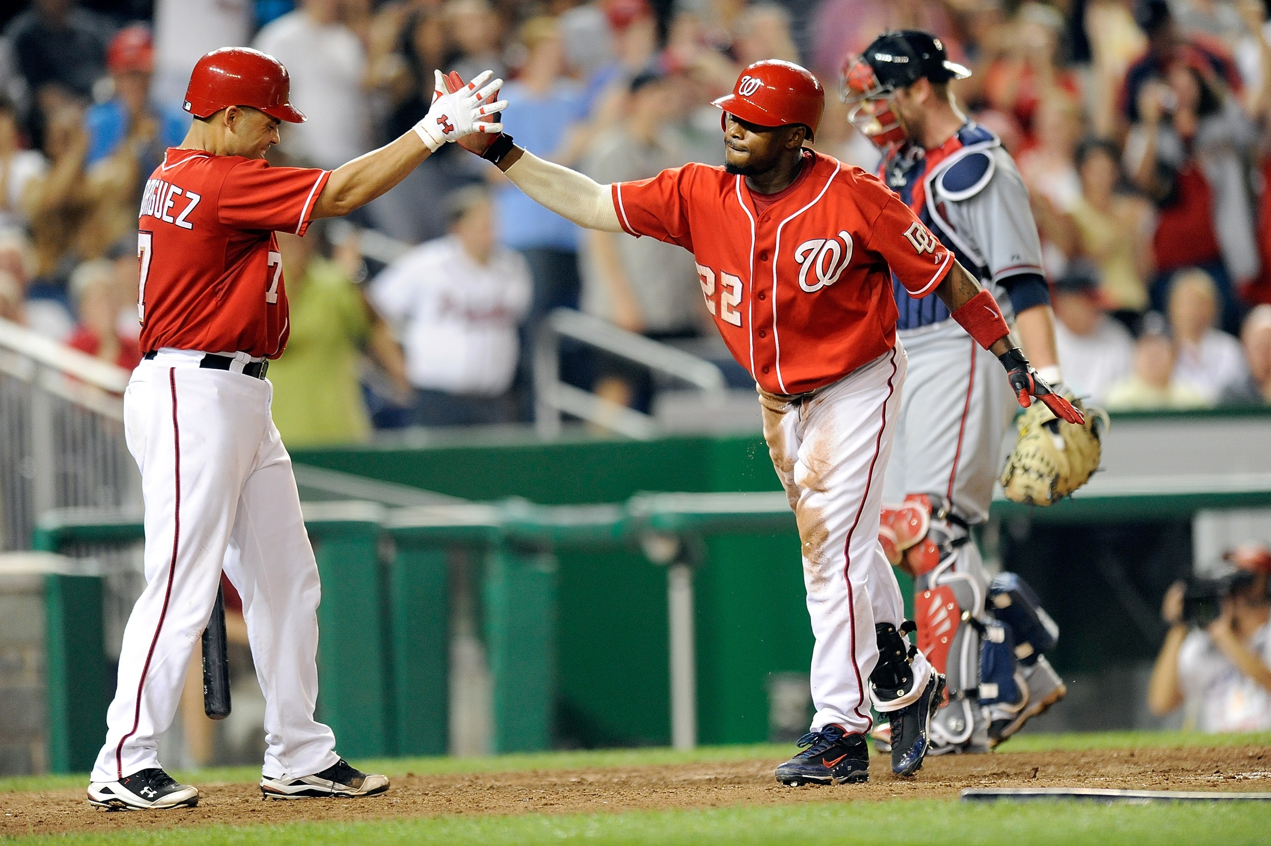 WASHINGTON - SEPTEMBER 24:  Willie Harris #22 of the Washington Nationals celebrates with Ivan Rodriguez #7 after hitting an inside the park home run in the seventh inning against the Atlanta Braves at Nationals Park on September 24, 2010 in Washington, D