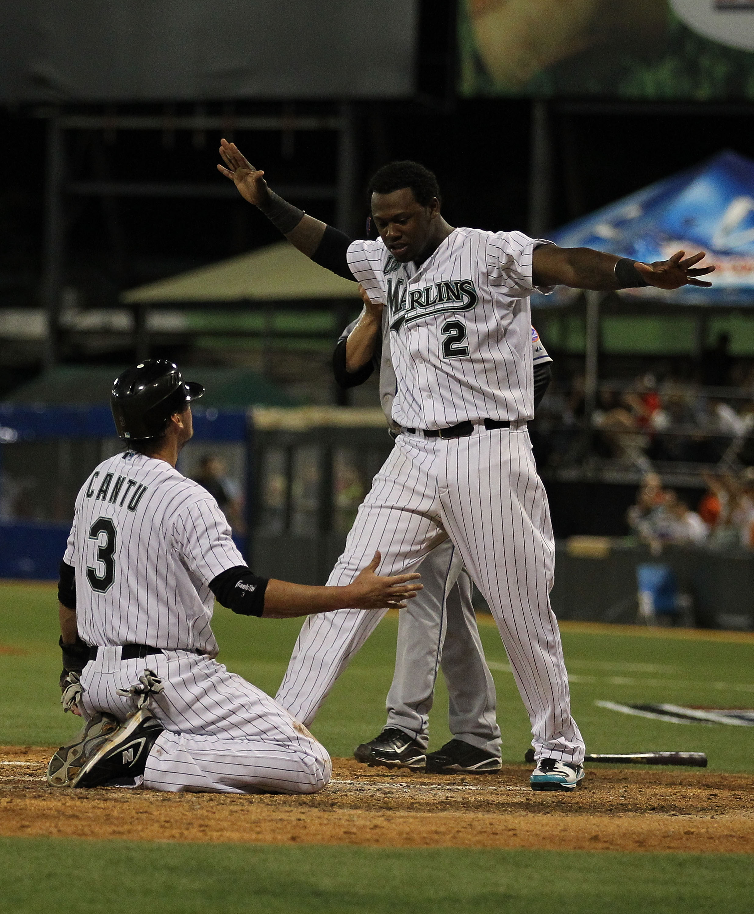 SAN JUAN, PUERTO RICO - JUNE 29:  Jorge Cantu #3 and Hanley Ramirez #2 of the Florida Marlins celebrate after Cantu scored the winning run off of a hit by Dan Uggla #6 as Rod Barajas #21 of the New York Mets is late with the tag in the bottom of the ninth