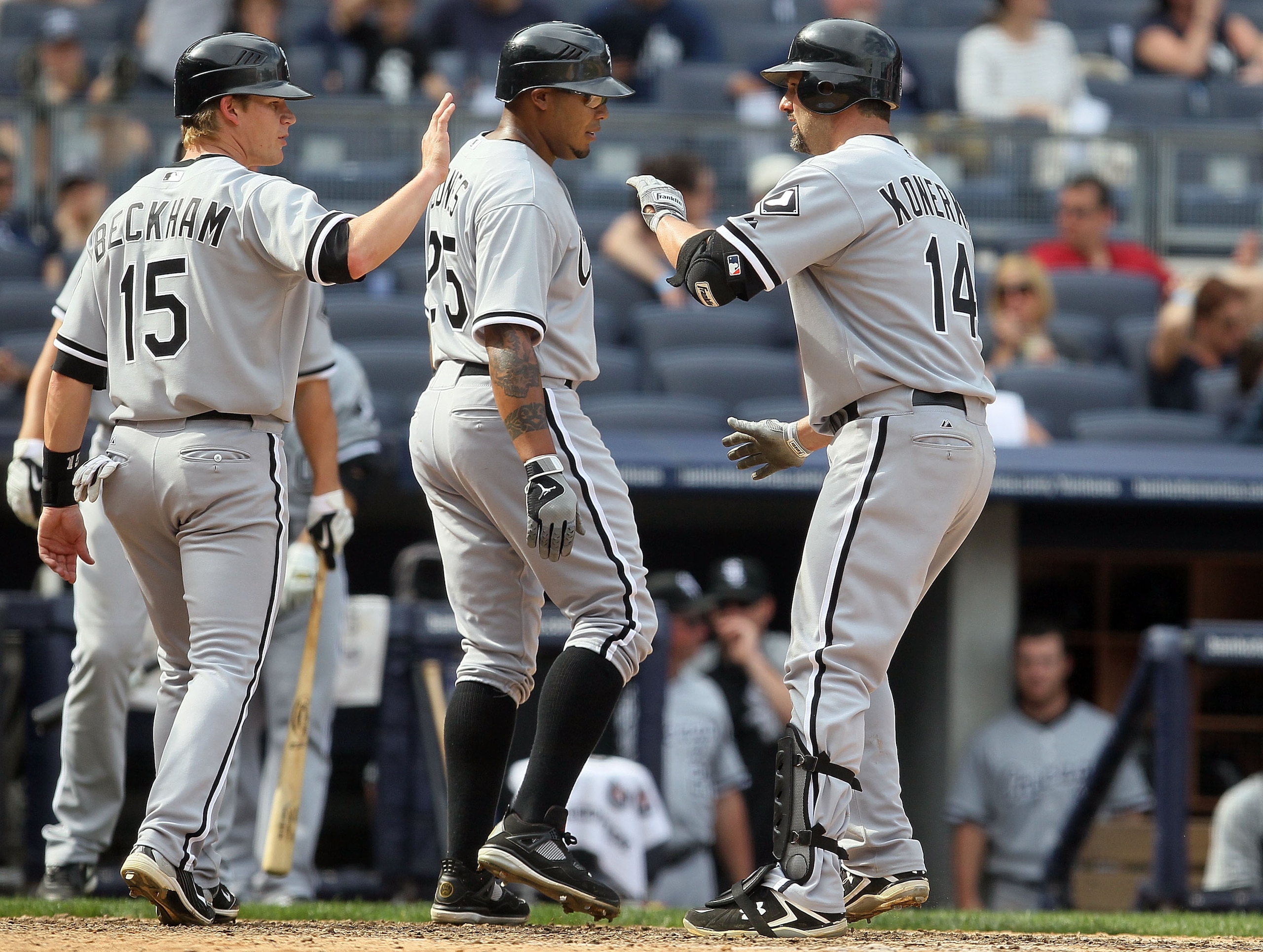NEW YORK - MAY 02:  Paul Konerko #14 of the Chicago White Sox celebrates his ninth inning three run home run against the New York Yankees with teammates Andruw Jones #25 and Gordon Beckham #15 on May 2, 2010 at Yankee Stadium in the Bronx borough of New Y