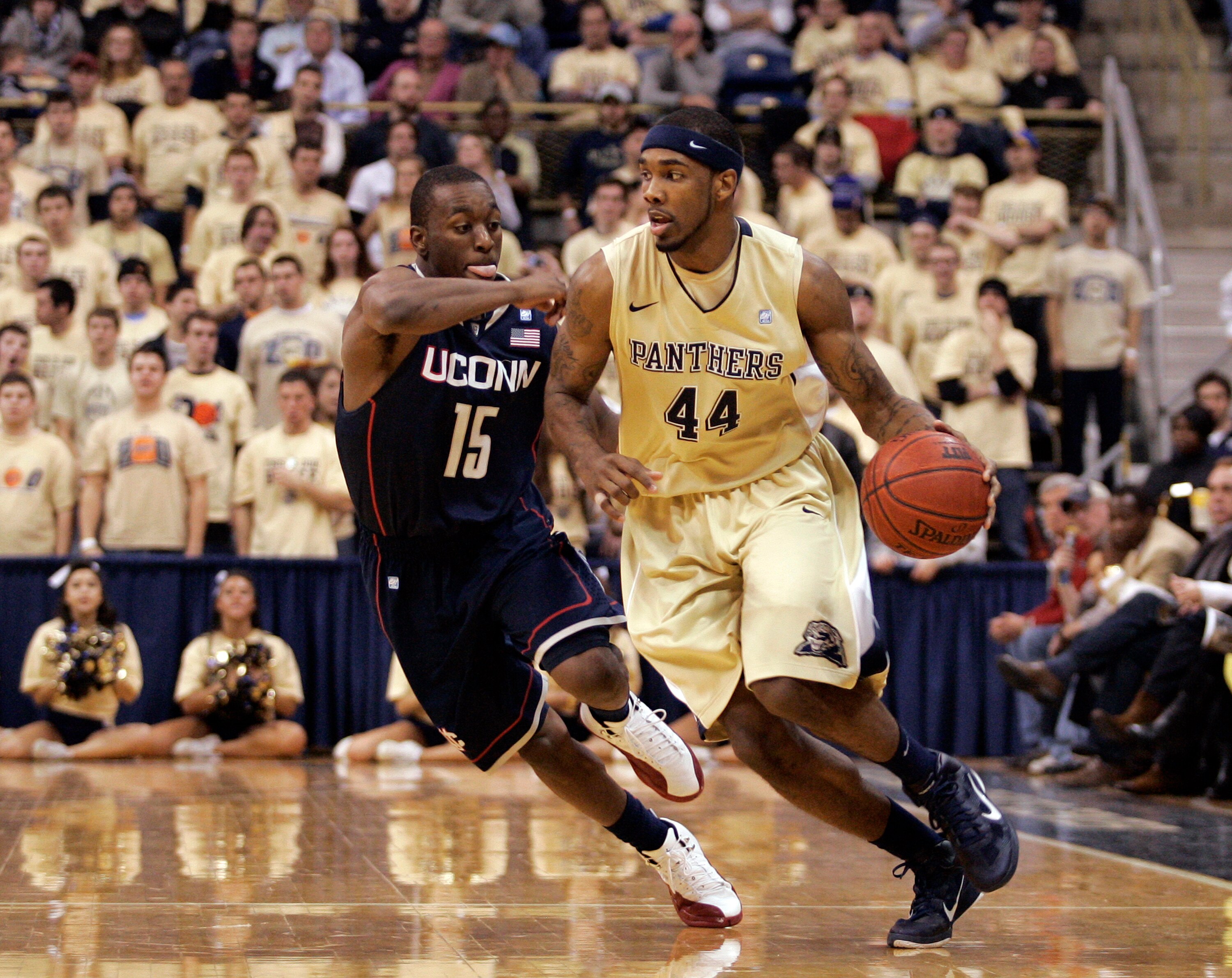 PITTSBURGH, PA - DECEMBER 27:  J.J. Moore #44 of the Pittsburgh Panthers brings the ball down court against Kemba Walker #15 of the Connecticut Huskies at Petersen Events Center on December 27, 2010 in Pittsburgh, Pennsylvania.  Pittsburgh defeated Connec