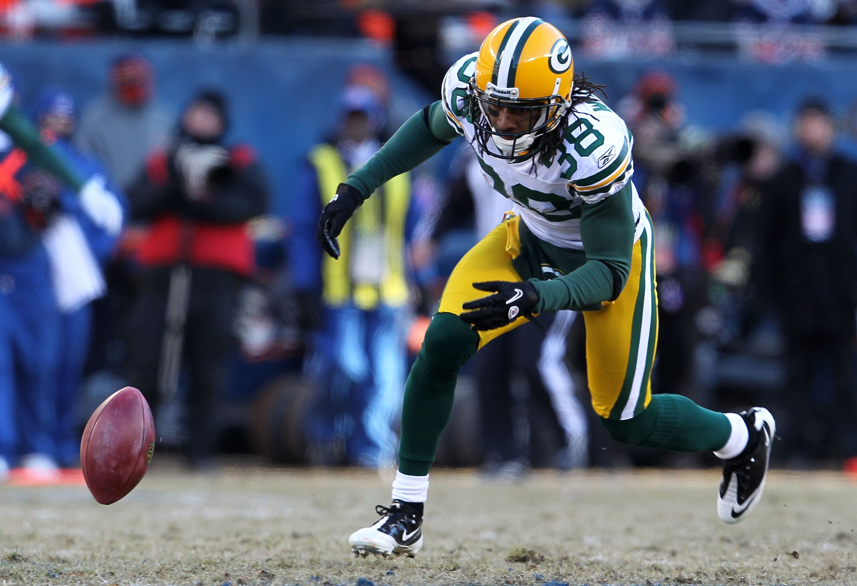 CHICAGO, IL - JANUARY 23:  Tramon Williams #38 of the Green Bay Packers drops a punt against the Chicago Bears in the NFC Championship Game at Soldier Field on January 23, 2011 in Chicago, Illinois.  (Photo by Jamie Squire/Getty Images)
