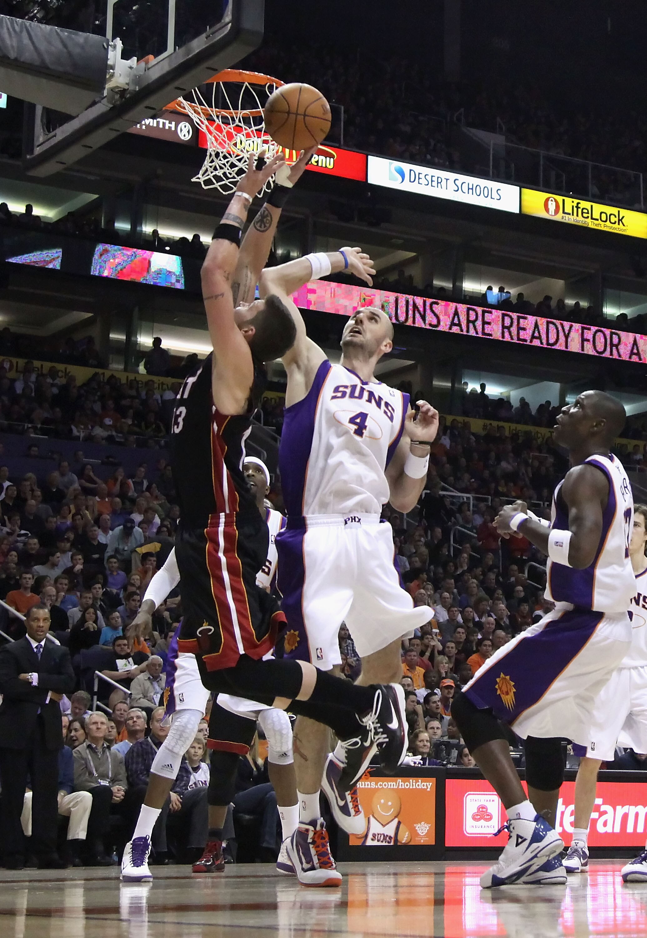 PHOENIX - DECEMBER 23:  Marcin Gortat #4 of the Phoenix Suns battles for a rebound against the Miami Heat during the NBA game at US Airways Center on December 23, 2010 in Phoenix, Arizona. The Heat defeated the Suns 95-83. NOTE TO USER: User expressly ack
