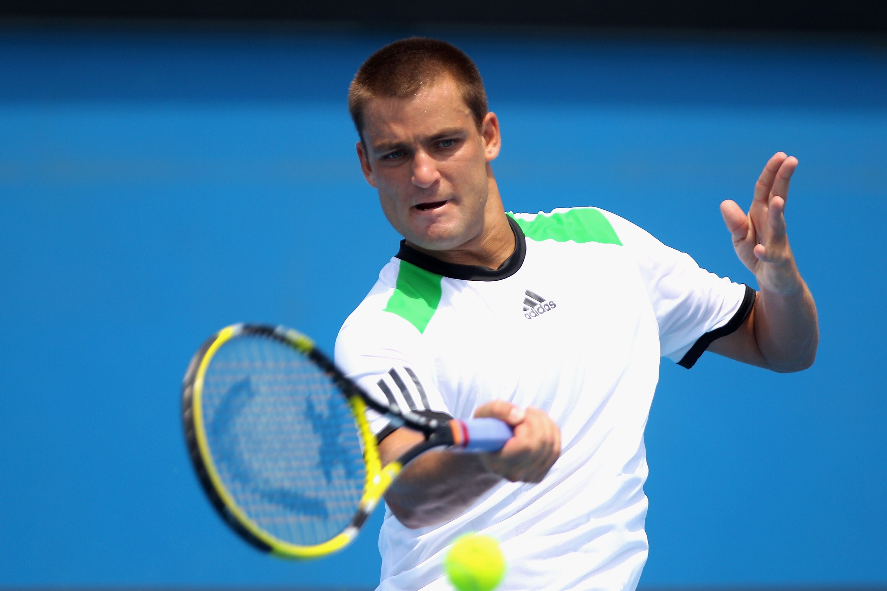 MELBOURNE, AUSTRALIA - JANUARY 22:  Mikhail Youzhny of Russia plays a forehand during his third round match against Milos Raonic of Canada during day six of the 2011 Australian Open at Melbourne Park on January 22, 2011 in Melbourne, Australia.  (Photo by