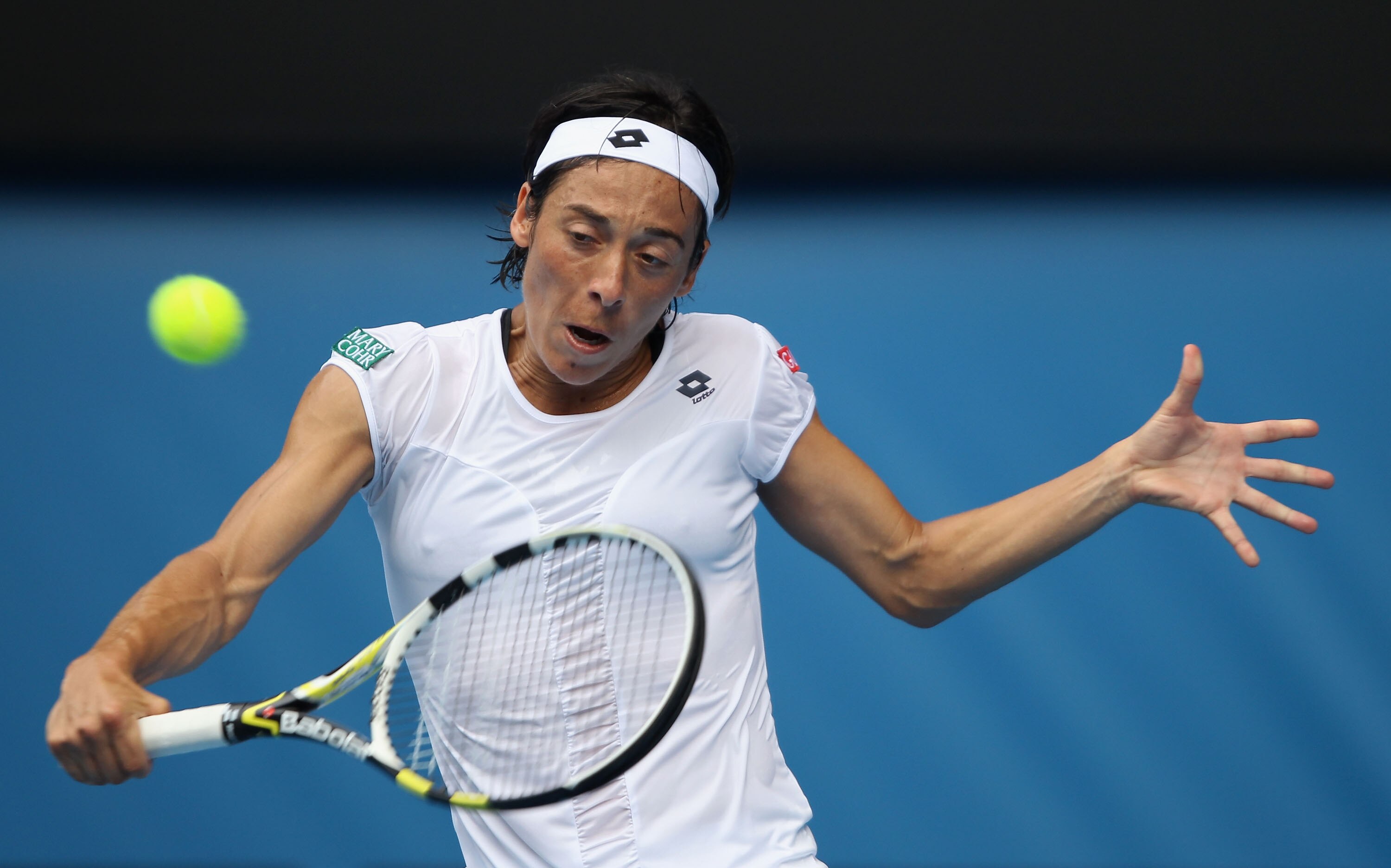 MELBOURNE, AUSTRALIA - JANUARY 25:   Francesca Schiavone of Italy plays a backhand during her quarterfinal match against Caroline Wozniacki of Denmark during day nine of the 2011 Australian Open at Melbourne Park on January 25, 2011 in Melbourne, Australi