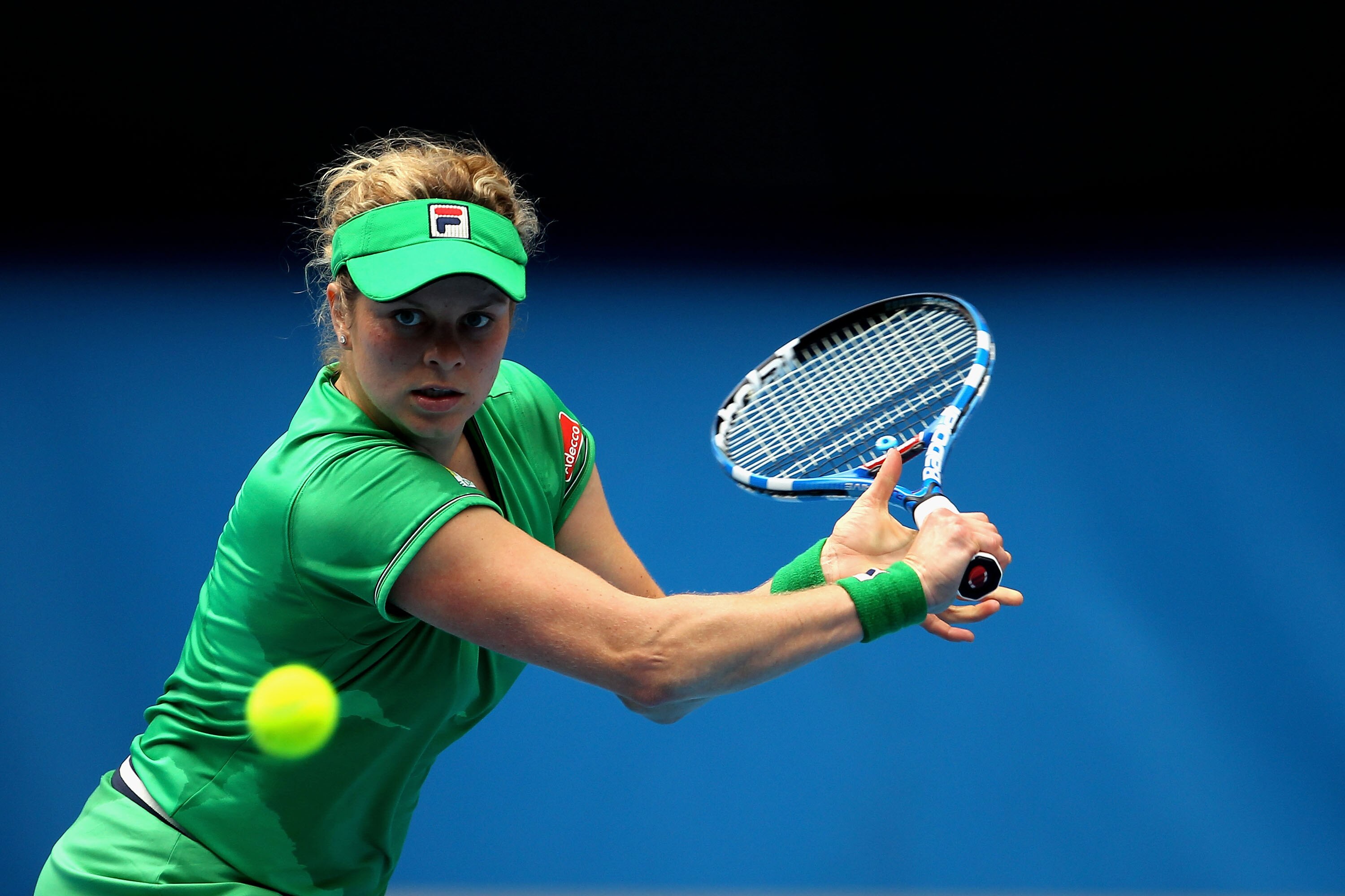 MELBOURNE, AUSTRALIA - JANUARY 26:  Kim Clijsters of Belgium plays a backhand in her quarterfinal match against Agnieszka Radwanska of Poland during day ten of the 2011 Australian Open at Melbourne Park on January 26, 2011 in Melbourne, Australia.  (Photo