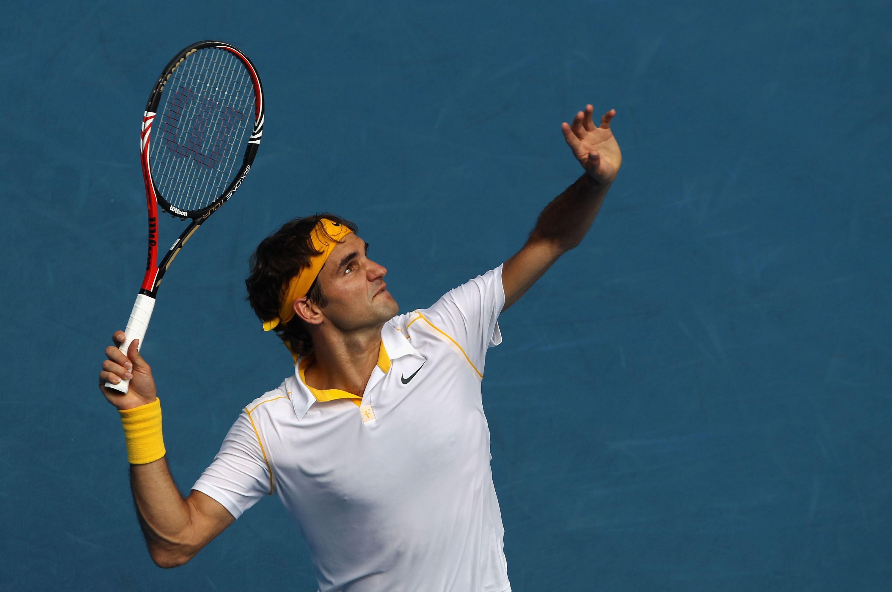 MELBOURNE, AUSTRALIA - JANUARY 25:  Roger Federer of Switzerland serves in his quarterfinal match against Stanislas Wawrinka of Switzerland during day nine of the 2011 Australian Open at Melbourne Park on January 25, 2011 in Melbourne, Australia.  (Photo