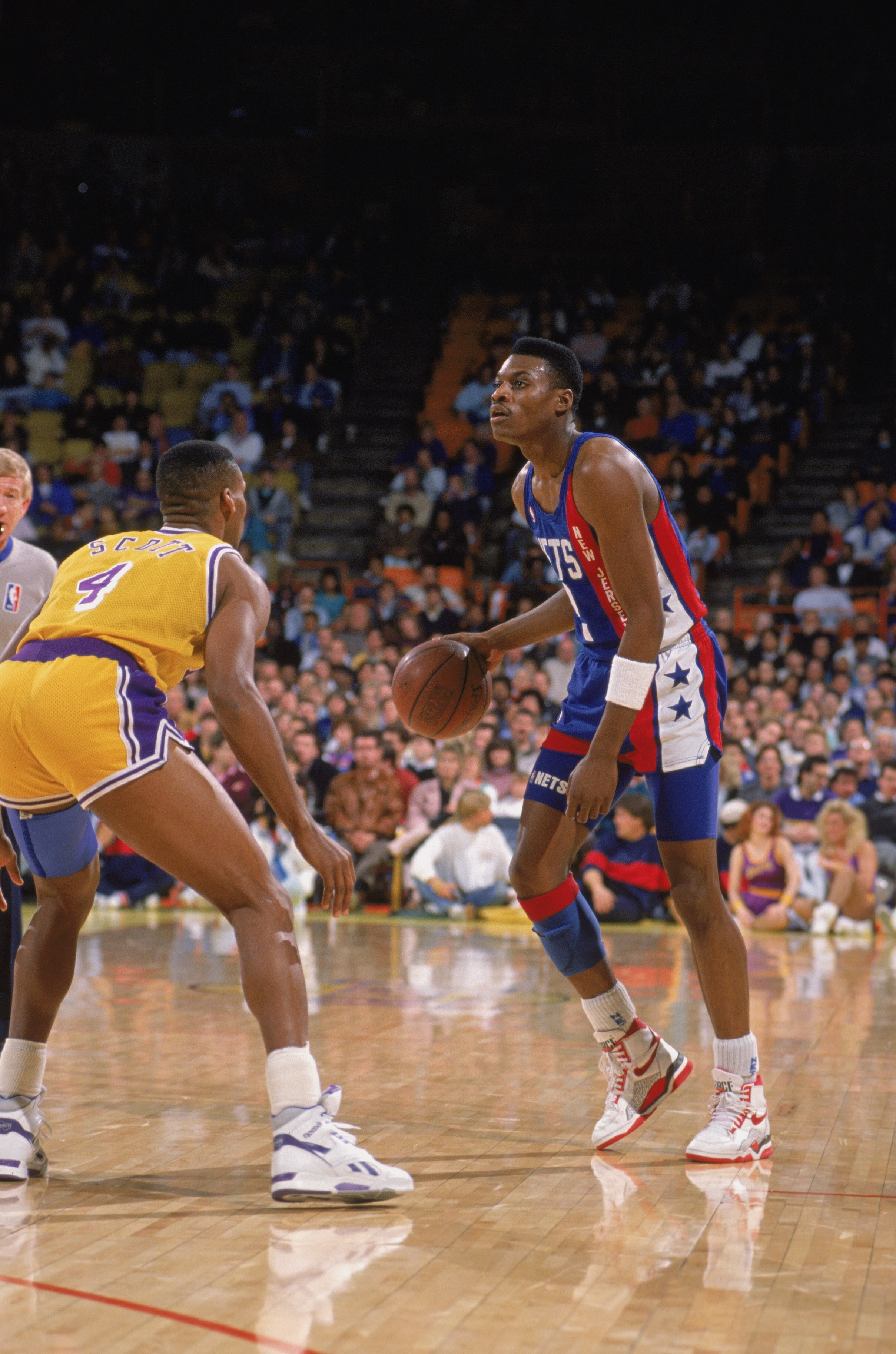 LOS ANGELES - 1990:  Dennis Hopson #2 of the New Jersey Nets dribbles the ball as Byron Scott #4 of the Los Angeles Lakers defends during the NBA game at the Great Western Forum in Los Angeles, California in 1990. NOTE TO USER: User expressly acknowledges