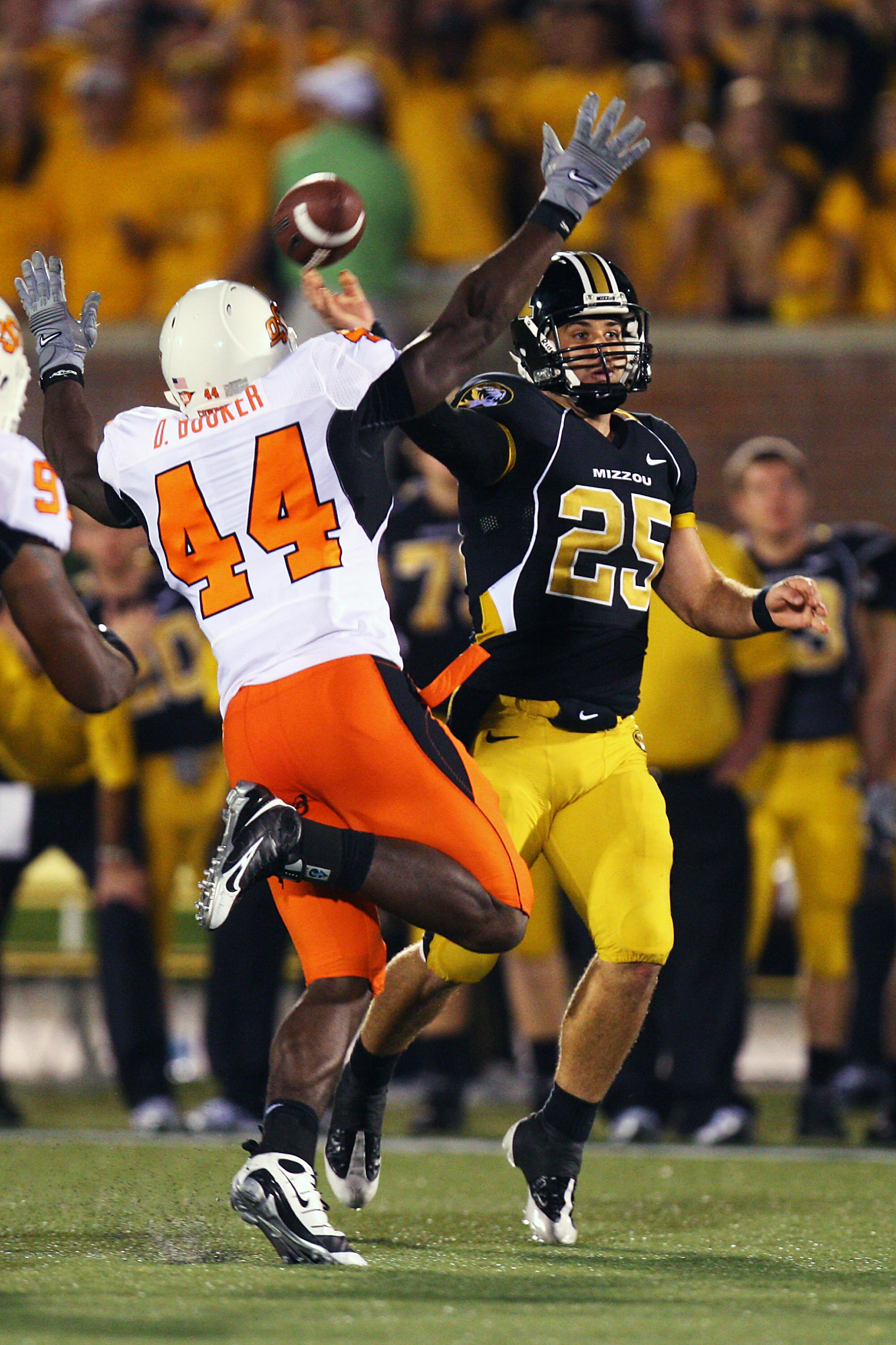 COLUMBIA, MO - OCTOBER 11:  Chase Daniel #25 of the Missouri Tigers throws a pass under pressure from Donald Boooker #44 of the Oklahoma State Cowboys on October 11, 2008 at Memorial Stadium in Columbia, Missouri.  Daniel was wearing #25 in honor of Aaron