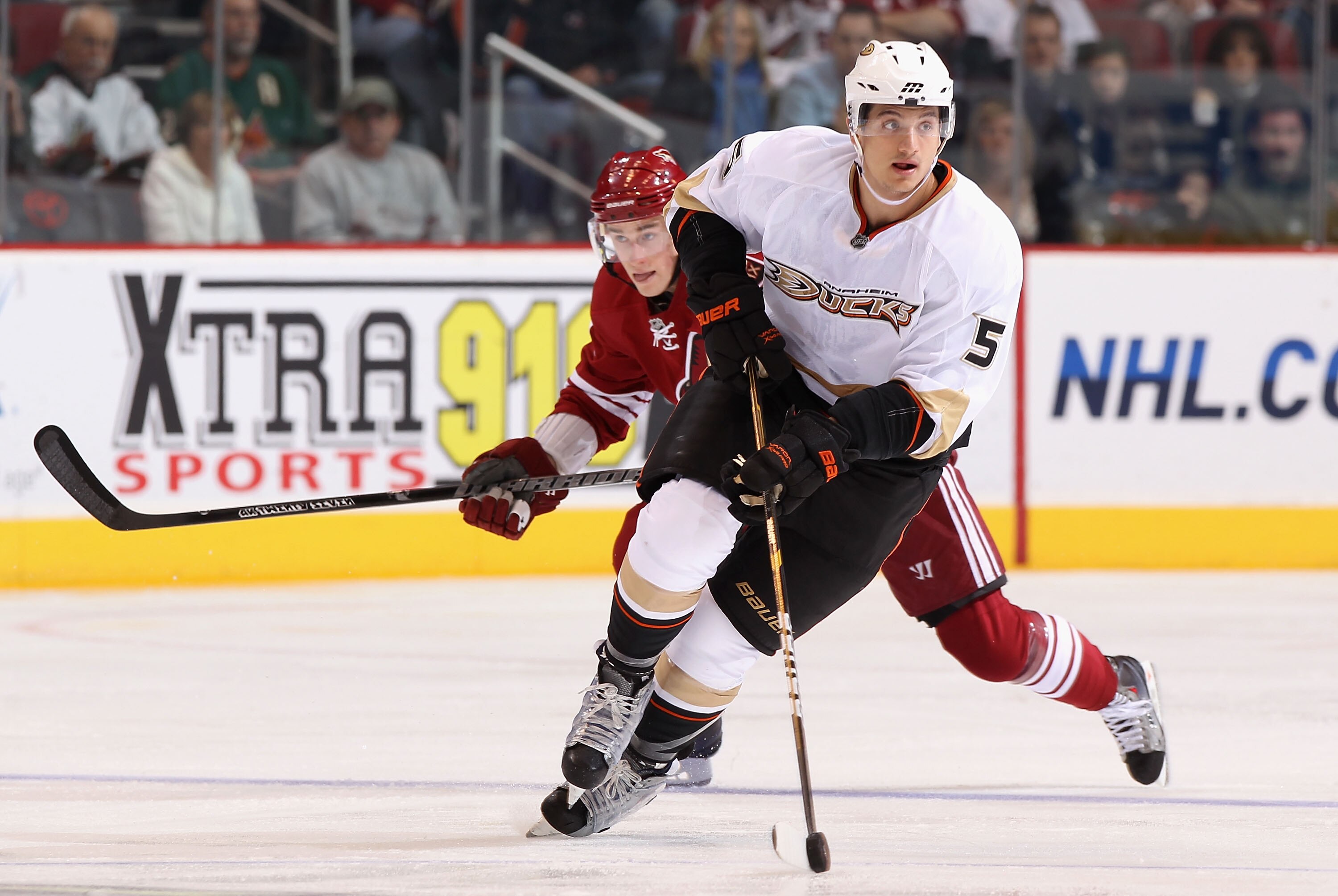 GLENDALE, AZ - JANUARY 15:  Luca Sbisa #5 of the Anaheim Ducks skates with the puck up ice past Kyle Turris #91 of the Phoenix Coyotes during the NHL game at Jobing.com Arena on January 15, 2011 in Glendale, Arizona. The Coyotes defeated the Ducks 6-2. (P