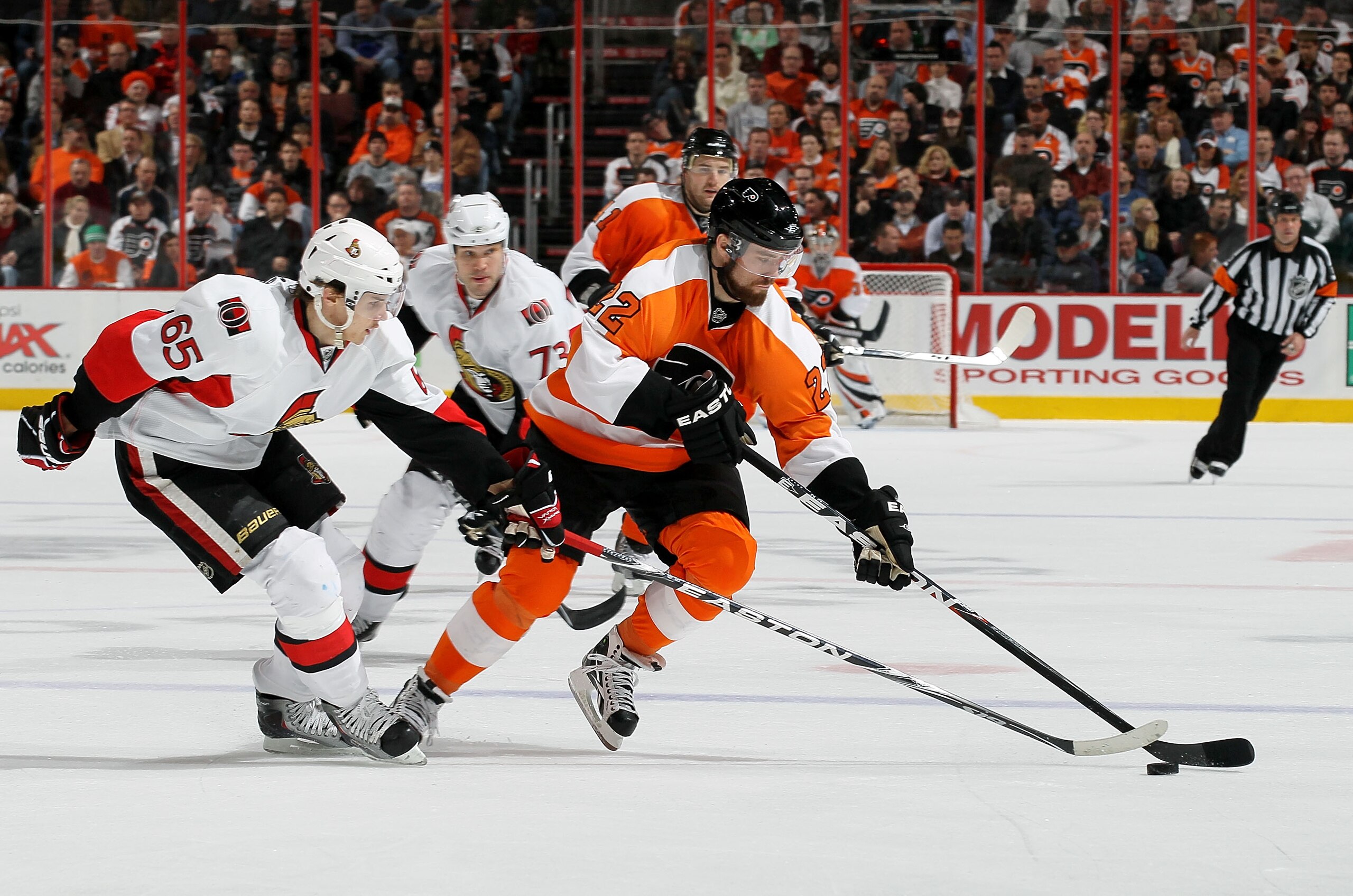 PHILADELPHIA, PA - JANUARY 20: Ville Leino #22 of the Philadelphia Flyers carries the puck past Erik Karlsson #65 of the Ottawa Senators on January 20, 2011 at Wells Fargo Center in Philadelphia, Pennsylvania.  (Photo by Jim McIsaac/Getty Images)