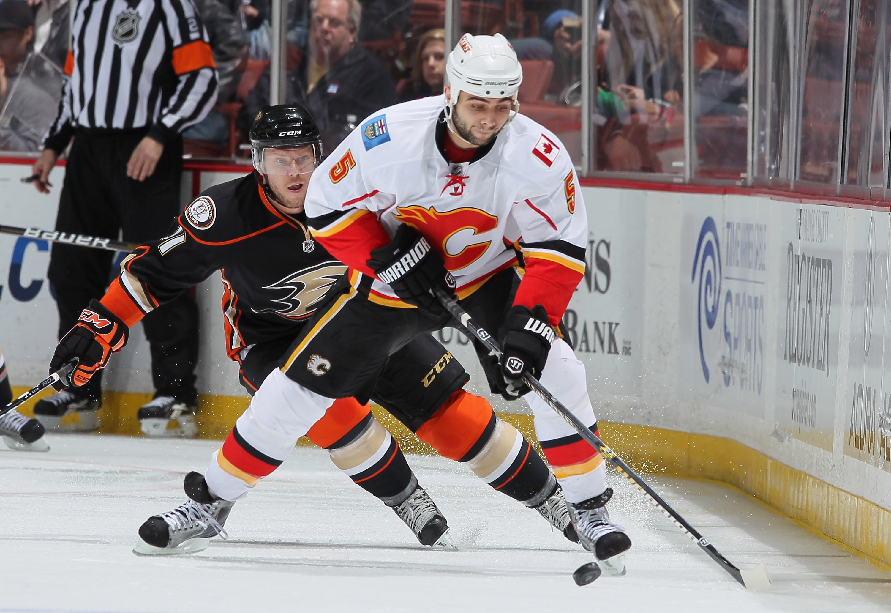 ANAHEIM, CA - DECEMBER 10:  Mark Giordano #5 of the Calgary Flames is pursued by Saku Koivu #11 of the Anaheim Ducks in the first period at the Honda Center on December 10, 2010 in Anaheim, California.  (Photo by Jeff Gross/Getty Images)