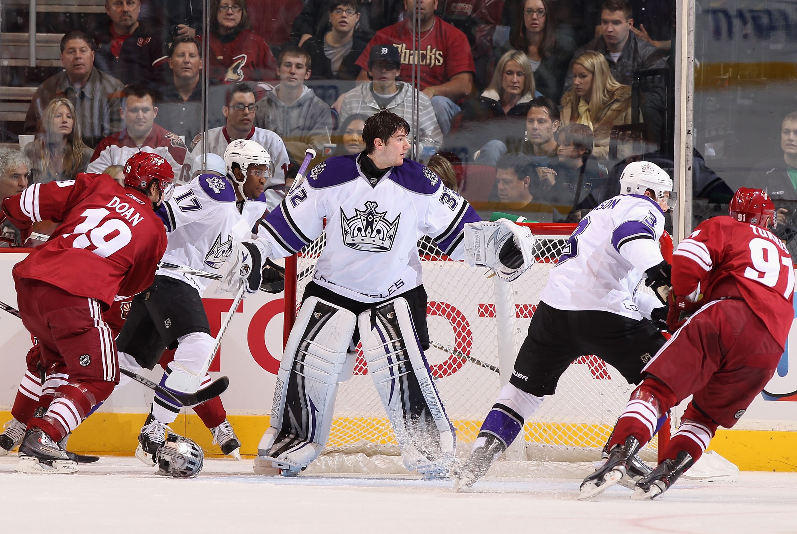GLENDALE, AZ - JANUARY 22:  Goaltender Jonathan Quick #32 of the Los Angeles Kings reacts after losing his mask during play in the NHL game against the Phoenix Coyotes at Jobing.com Arena on January 22, 2011 in Glendale, Arizona. The Kings defeated the Co