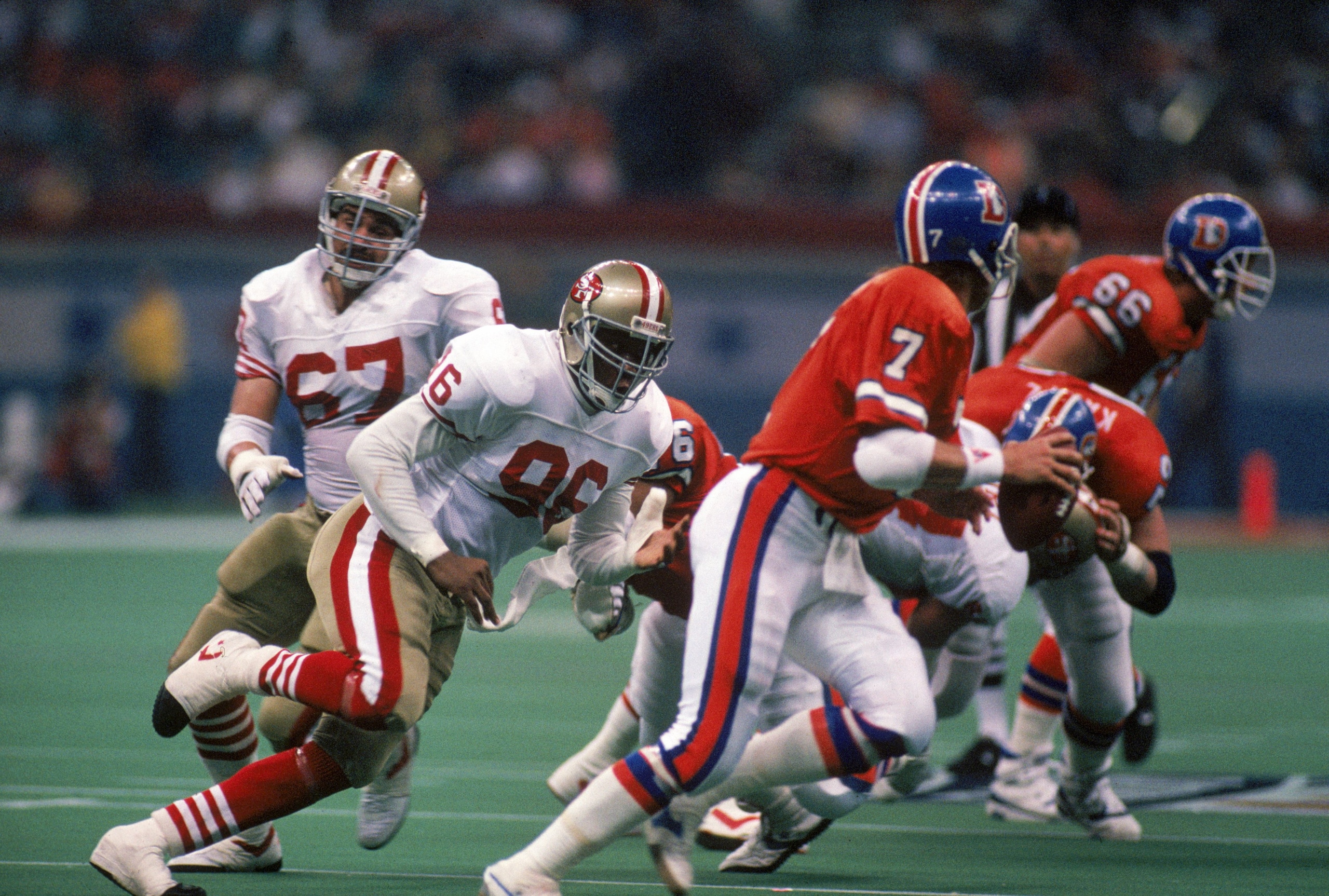 NEW ORLEANS - JANUARY 28: Defensive end Daniel Stubbs #96 of the San Francisco 49ers pursues Denver Broncos quarterback John Elway #7 in Super Bowl XXIV at Louisiana Superdome on January 28, 1990 in New Orleans, Louisiana. The 49ers won 55-10. (Photo b NEW ORLEANS - JANUARY 28: Defensive end Daniel Stubbs #96 of the San Francisco 49ers pursues Denver Broncos quarterback John Elway #7 in Super Bowl XXIV at Louisiana Superdome on January 28, 1990 in New Orleans, Louisiana. The 49ers won 55-10. (Photo b
