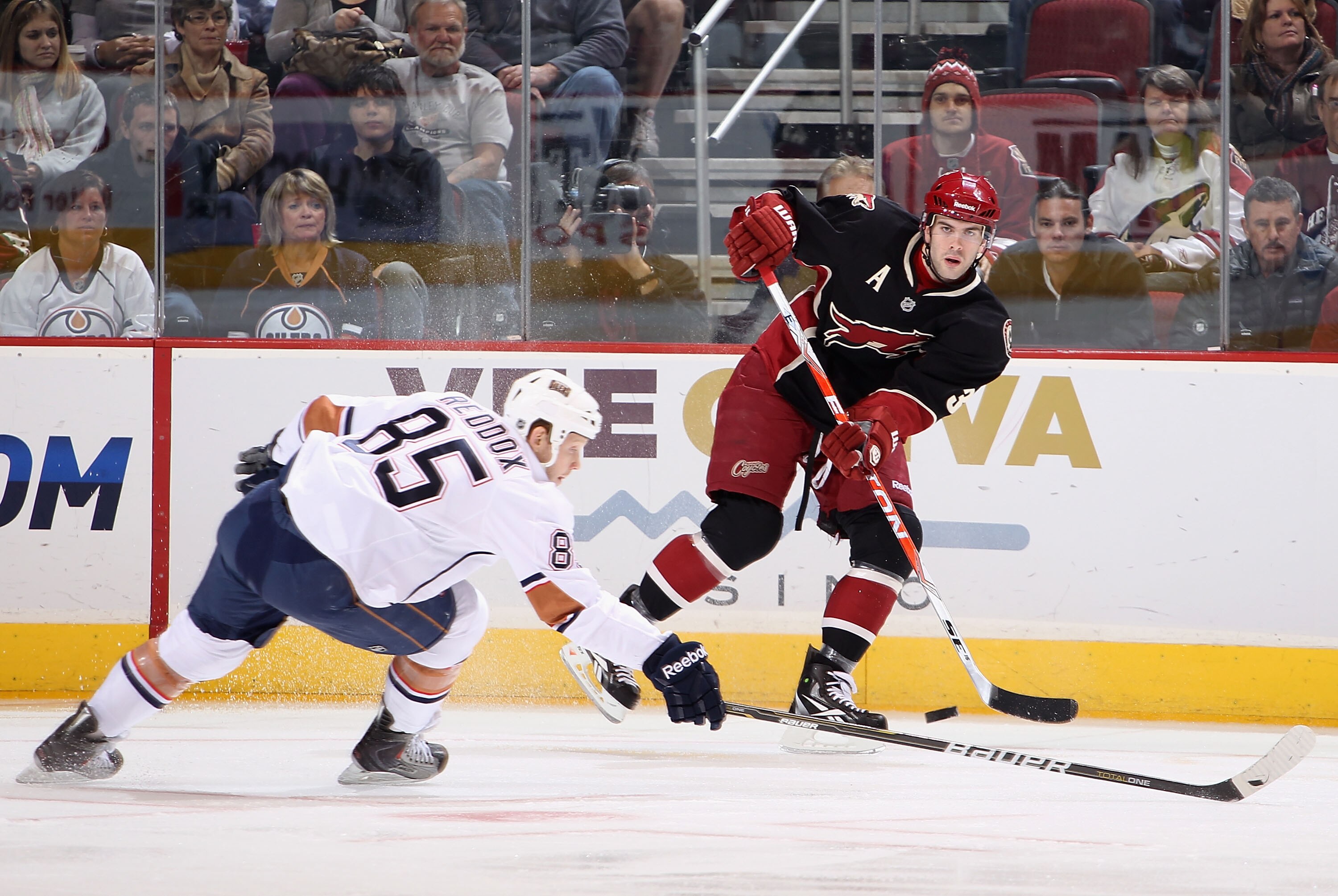 GLENDALE, AZ - JANUARY 25:  Keith Yandle #3 of the Phoenix Coyotes passes the puck over the stick of Liam Reddox #85 of the Edmonton Oilers during the NHL game at Jobing.com Arena on January 25, 2011 in Glendale, Arizona.  (Photo by Christian Petersen/Get