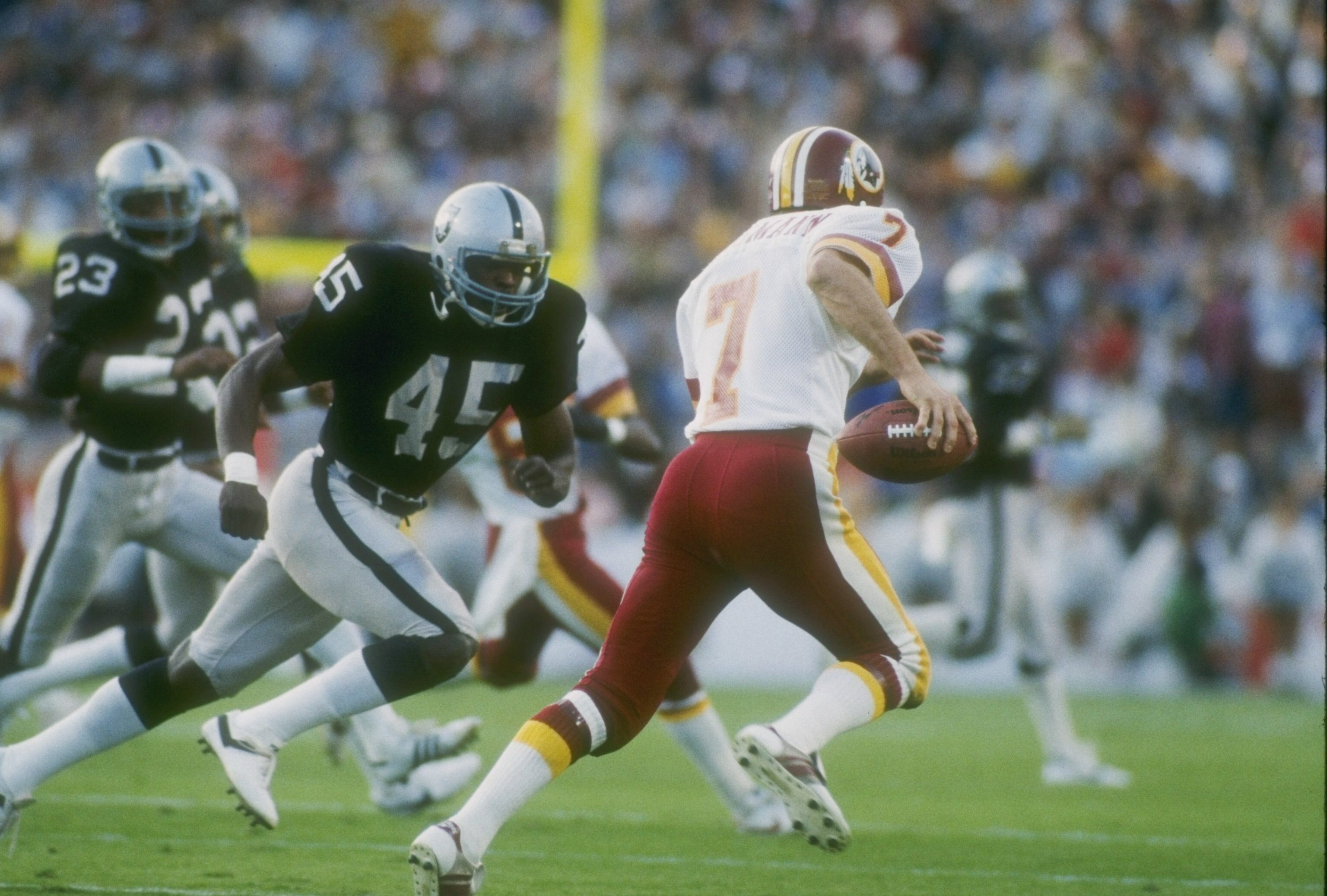 22 Jan 1984: Quarterback Joe Theismann #7 of the Washington Redskins keeps moving during Super Bowl XVIII against the Los Angeles Raiders at Tampa Stadium in Tampa, Florida.The Raiders won the game 38-9. Mandatory Credit: Allsport /Allsport 22 Jan 1984: Quarterback Joe Theismann #7 of the Washington Redskins keeps moving during Super Bowl XVIII against the Los Angeles Raiders at Tampa Stadium in Tampa, Florida.The Raiders won the game 38-9. Mandatory Credit: Allsport /Allsport
