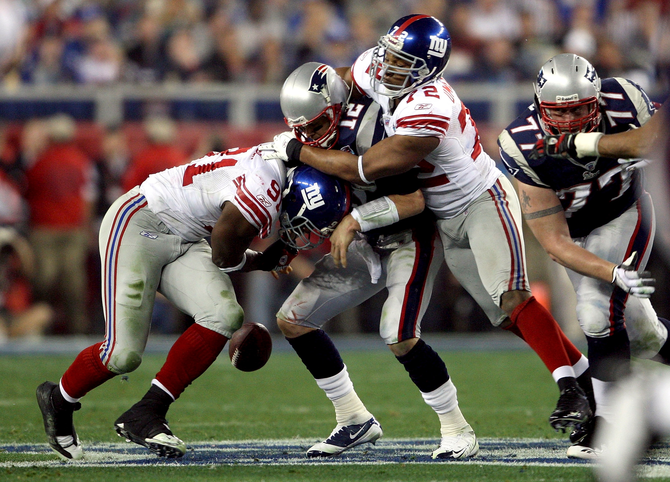 GLENDALE, AZ - FEBRUARY 03: Tom Brady #12 of of the New England Patriots fumbles the ball in the second quarter as he is hit by Justin Tuck #91 and Osi Umenyiora #72 of the New York Giants during Super Bowl XLII on February 3, 2008 at the University of P GLENDALE, AZ - FEBRUARY 03: Tom Brady #12 of of the New England Patriots fumbles the ball in the second quarter as he is hit by Justin Tuck #91 and Osi Umenyiora #72 of the New York Giants during Super Bowl XLII on February 3, 2008 at the University of P