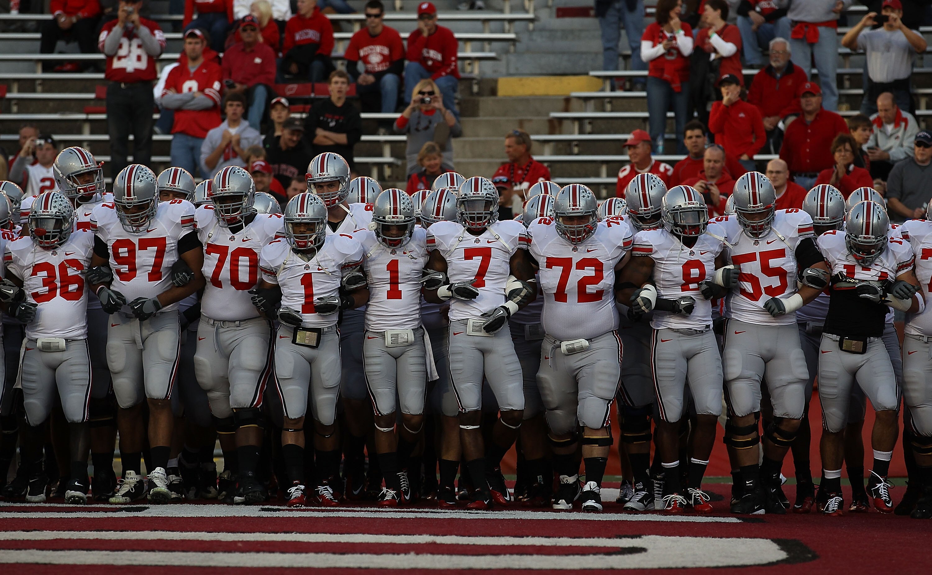 MADISON, WI - OCTOBER 16: Members of the Ohio State Buckeyes including Devon Torrence #1, Jermale Hines #7, Dexter Larimore #72 and Aaron Gant #8 walk on to the field for warm-ups before a game against the Wisconsin Badgers at Camp Randall Stadium on Octo