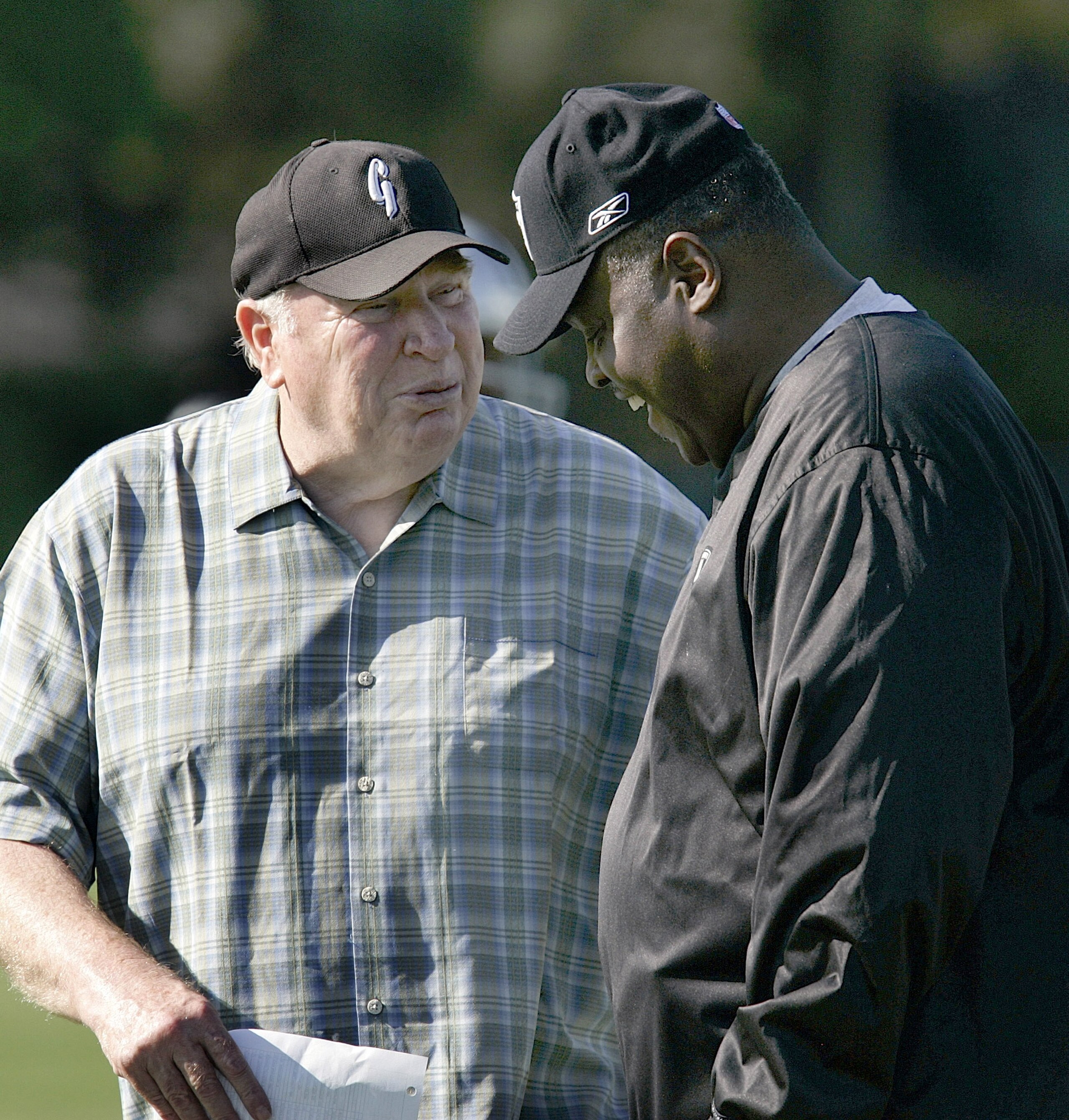 NAPA, CA - JULY 25:  (L-R) Former Raiders head coach and TV commentator John Madden and head coach Art Shell talk as they watch the Oakland Raiders start their camp at the Marriott Hotel on July 25, 2006 in Napa, California. (Photo by David Paul Morris/ G