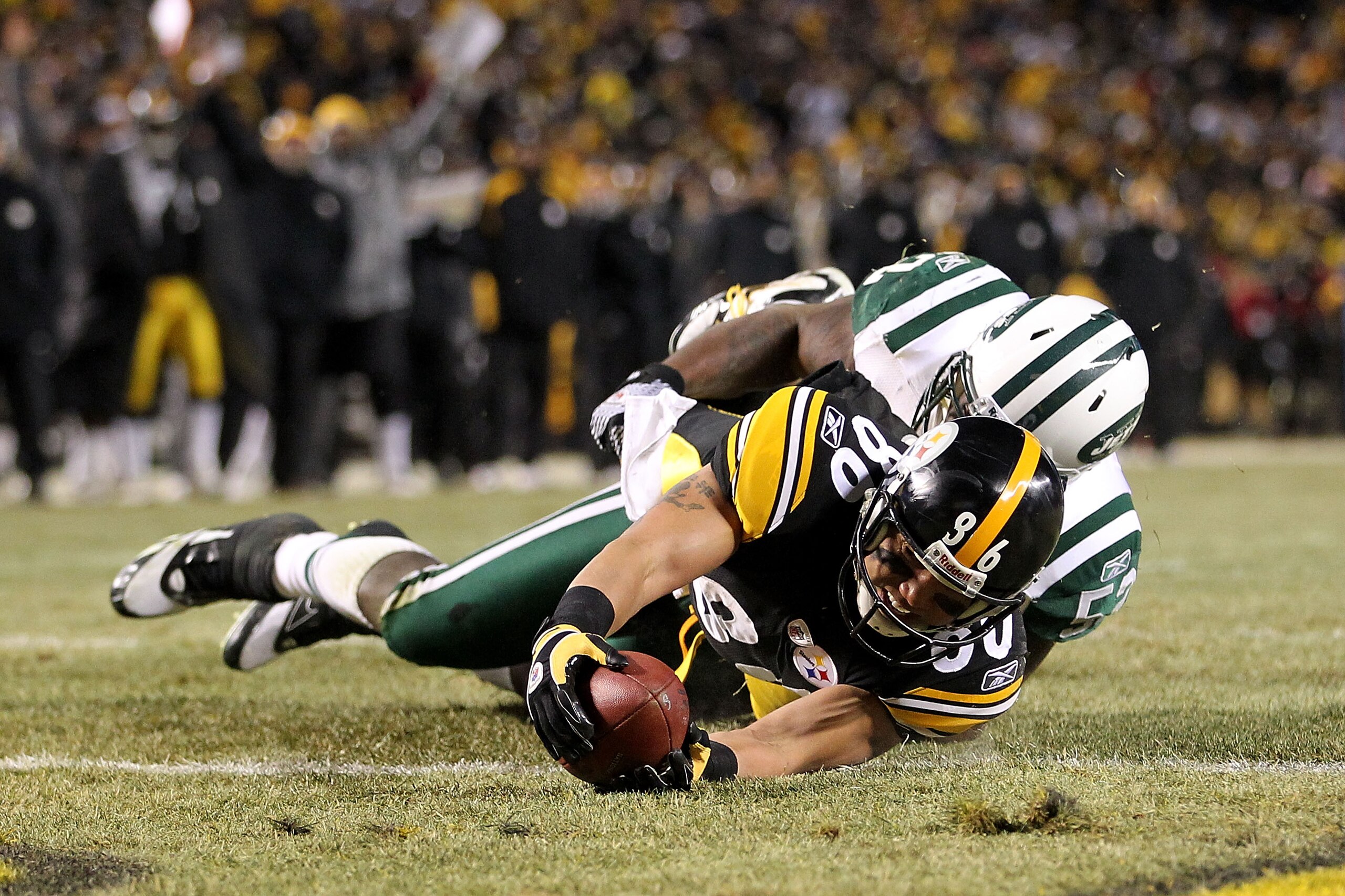 PITTSBURGH, PA - JANUARY 23:  Hines Ward #86 of the Pittsburgh Steelers catches the ball and is down on the one-yard line as he is tackled by David Harris #52 of the New York Jets during the 2011 AFC Championship game at Heinz Field on January 23, 2011 in