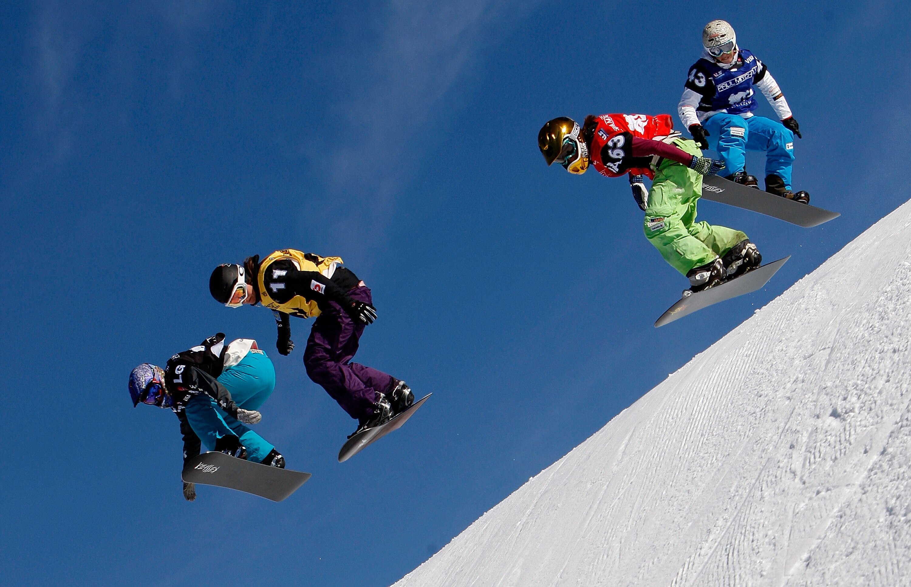TELLURIDE, CO - DECEMBER 20:  Lindsey Jacobellis (1st place) races Maelle Ricker of Canada (2nd place) as other riders try to catch up during the FIS Snowboardcross Team World Cup 2010 on December 20, 2009 in Telluride, Colorado.  (Photo by Streeter Lecka