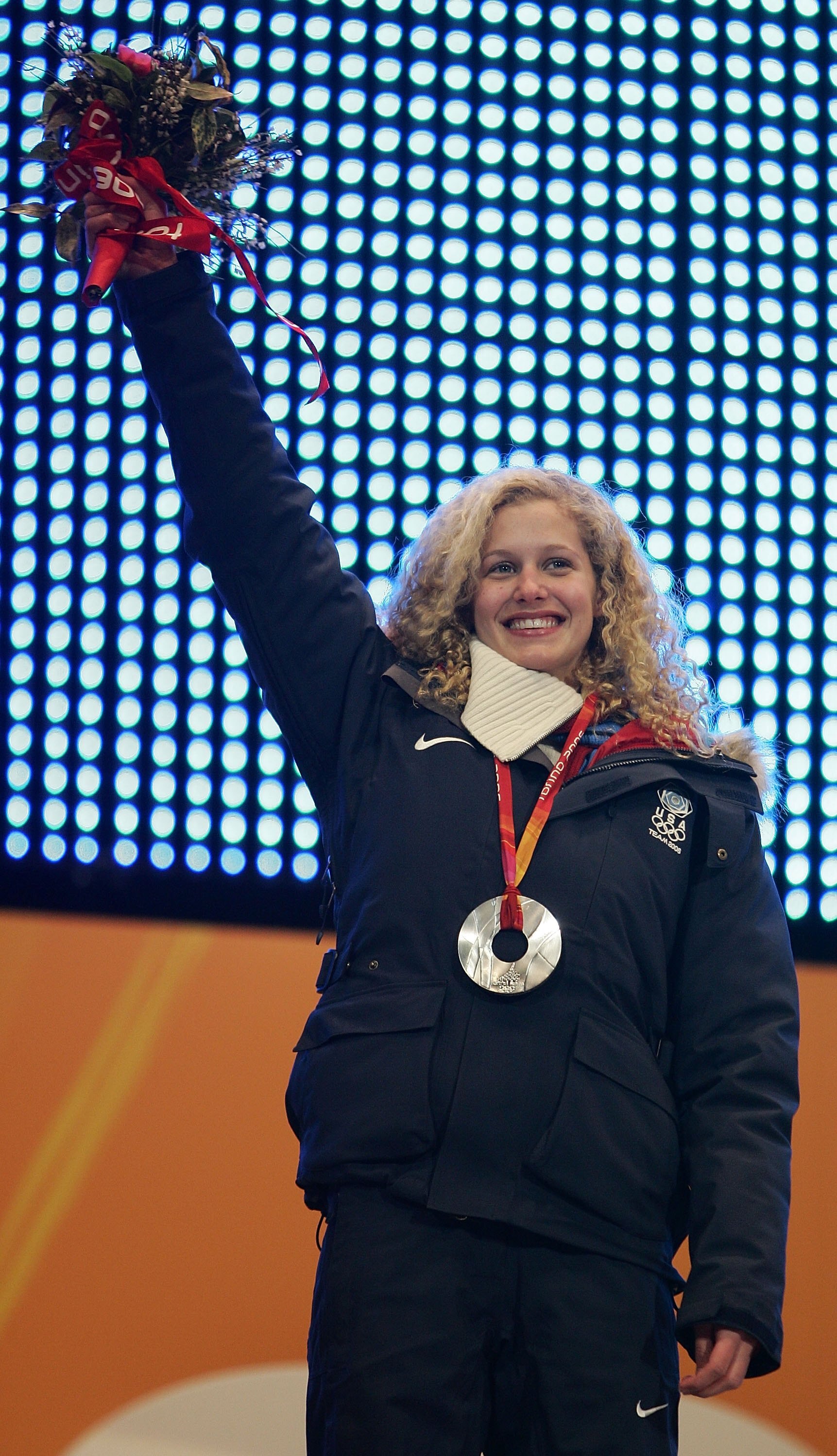 TURIN, ITALY - FEBRUARY 17:  Snowboard Cross Silver medalist Lindsey Jacobellis of the United States celebrates with her medal around her neck during the Medal Ceremony at the Turin 2006 Winter Olympic Games at the Medals Plaza on February 17, 2006 in Tur
