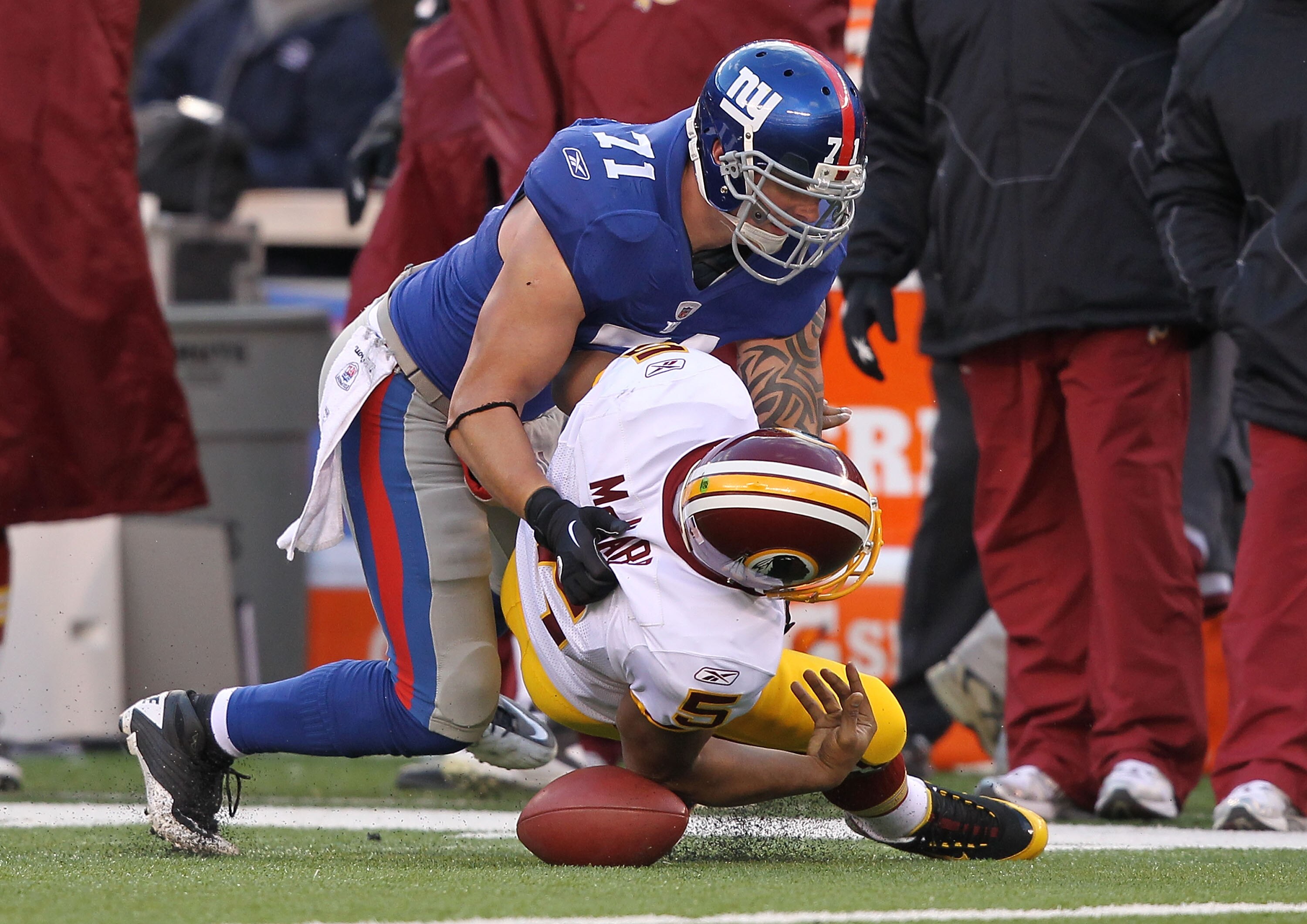 EAST RUTHERFORD, NJ - DECEMBER 05:  Dave Tollefson #71 of the New York Giants sacks Donovan McNabb #5 of the Washington Redskins who fumbles and the ball is recovered by Corey Webster #23 during their game on December 5, 2010 at The New Meadowlands Stadiu