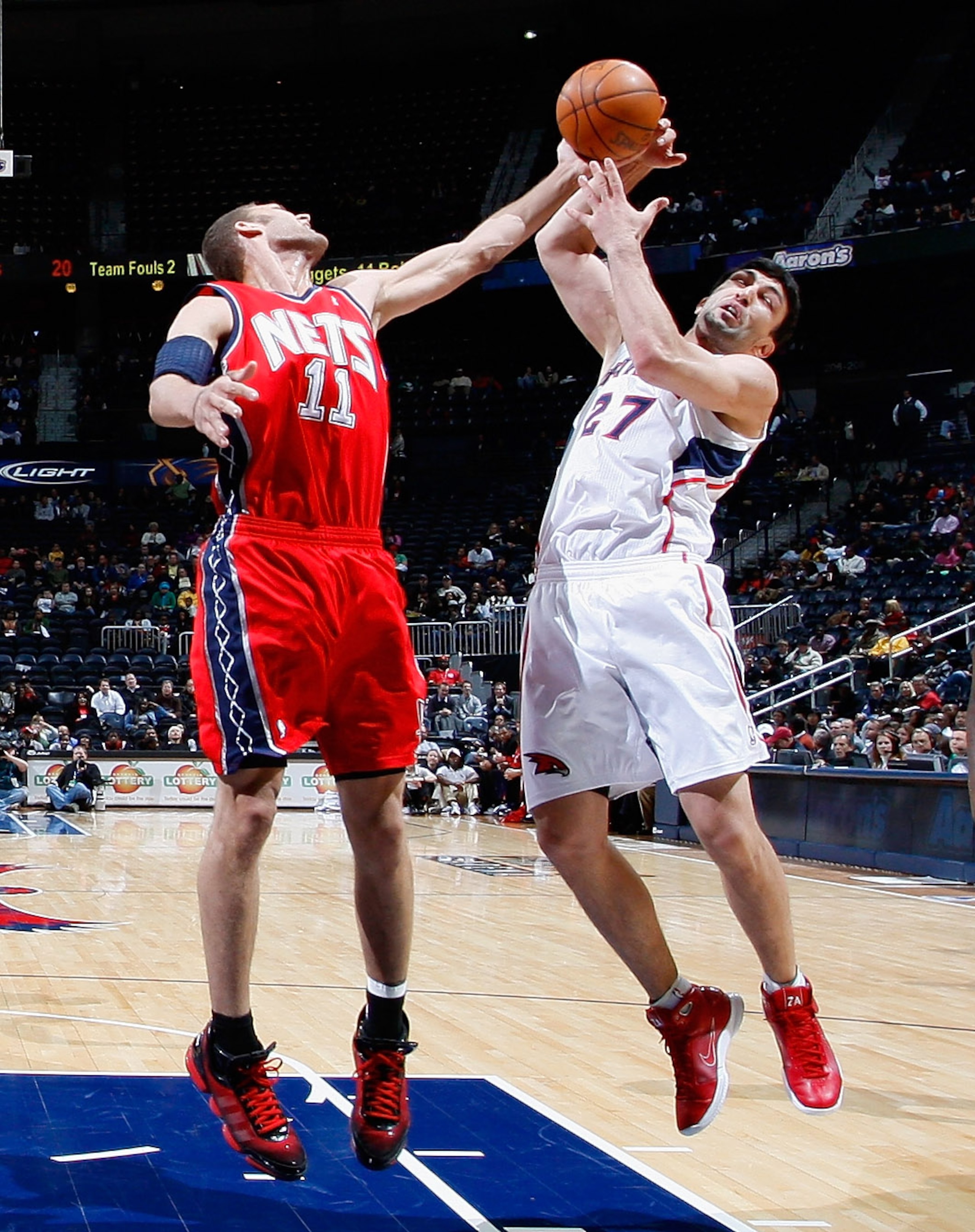 ATLANTA, GA - DECEMBER 07: Zaza Pachulia #27 of the Atlanta Hawks battles for a rebound against Brook Lopez #11 of the New Jersey Nets at Philips Arena on December 7, 2010 in Atlanta, Georgia. NOTE TO USER: User expressly acknowledges and agrees that, b ATLANTA, GA - DECEMBER 07: Zaza Pachulia #27 of the Atlanta Hawks battles for a rebound against Brook Lopez #11 of the New Jersey Nets at Philips Arena on December 7, 2010 in Atlanta, Georgia. NOTE TO USER: User expressly acknowledges and agrees that, b