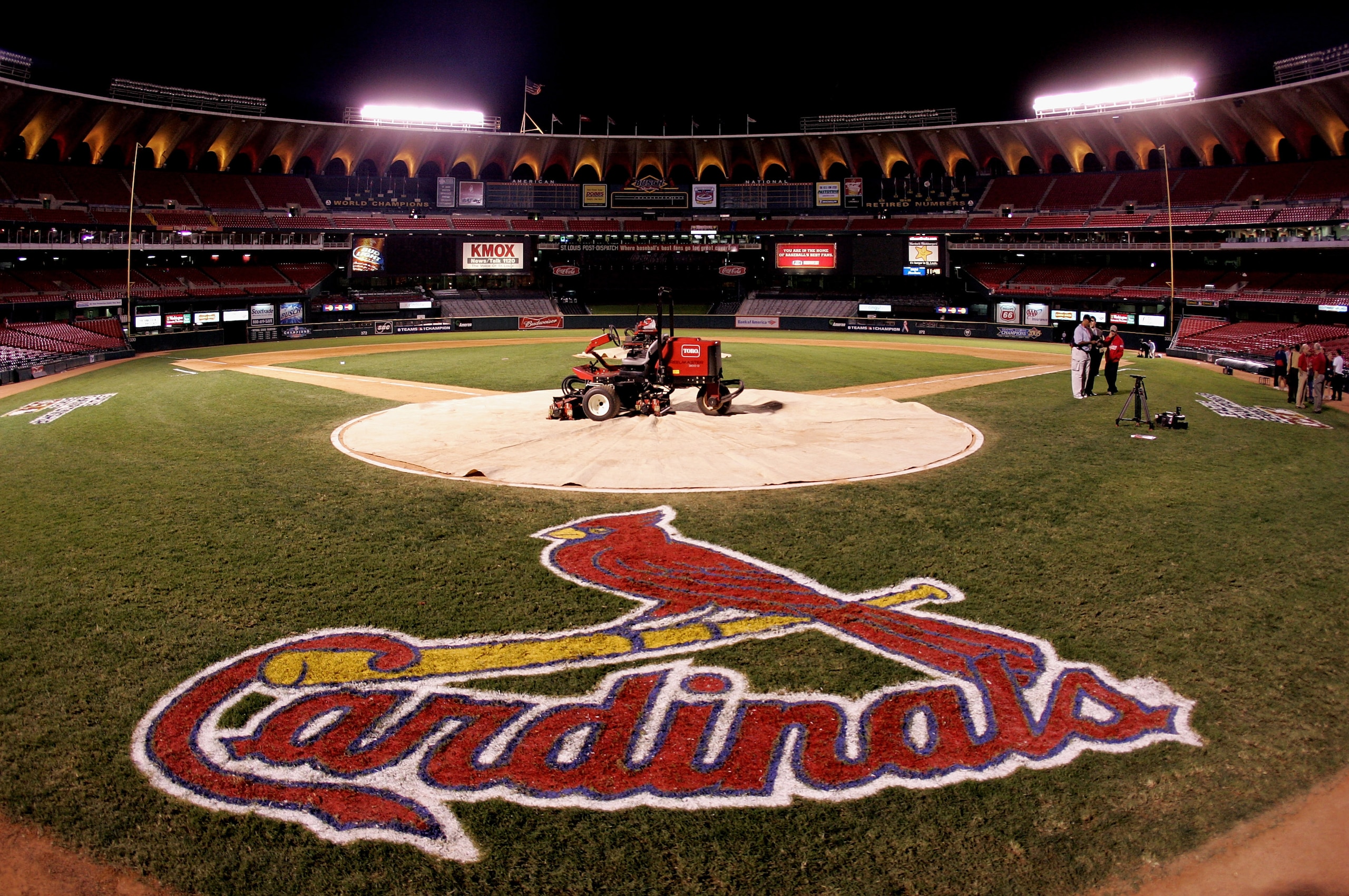 ST. LOUIS - OCTOBER 19:  A lawn mower is shown on home plate with a tarp as fans leave the stands following the St. Louis Cardinals 5-1 loss the Houston Astros during Game Six of the National League Championship Series October 19, 2005 at Busch Stadium in