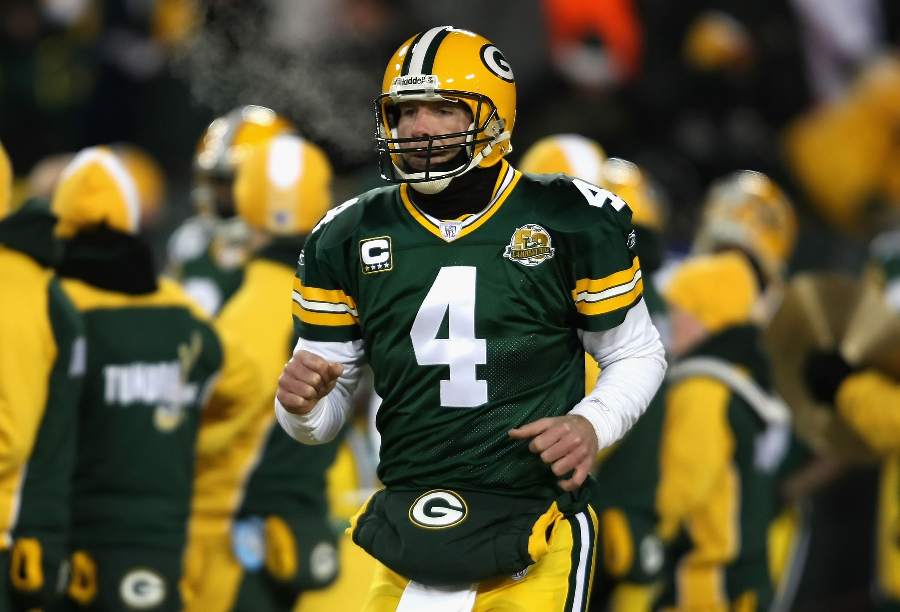 GREEN BAY, WI - JANUARY 20:  Quarterback Brett Favre #4 of the Green Bay Packers runs out onto the field before the NFC championship game against the New York Giants on January 20, 2008 at Lambeau Field in Green Bay, Wisconsin.  (Photo by Jonathan Daniel/