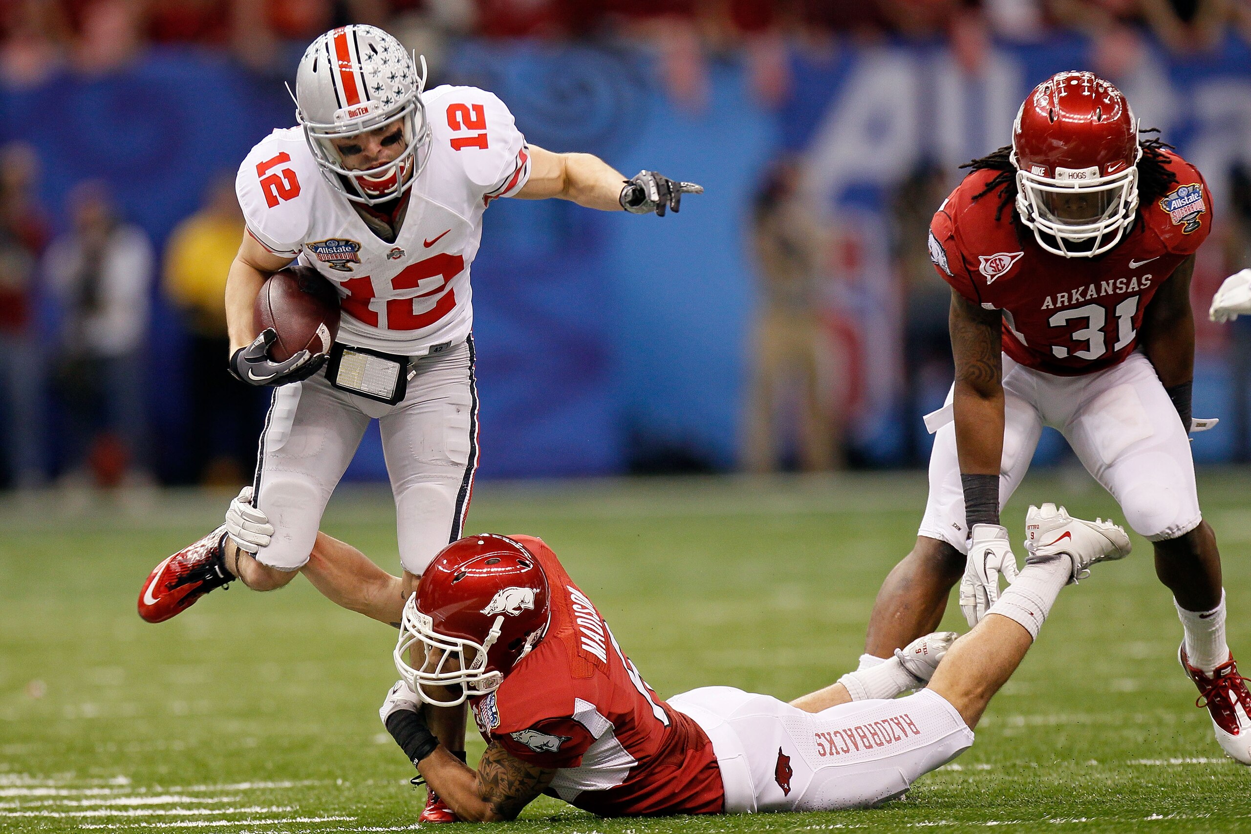 NEW ORLEANS, LA - JANUARY 04: Dane Sanzenbacher #12 of the Ohio State Buckeyes runs after a catch against Isaac Madison #6 of the Arkansas Razorbacks in the second quarter during the Allstate Sugar Bowl at the Louisiana Superdome on January 4, 2011 in Ne NEW ORLEANS, LA - JANUARY 04: Dane Sanzenbacher #12 of the Ohio State Buckeyes runs after a catch against Isaac Madison #6 of the Arkansas Razorbacks in the second quarter during the Allstate Sugar Bowl at the Louisiana Superdome on January 4, 2011 in Ne