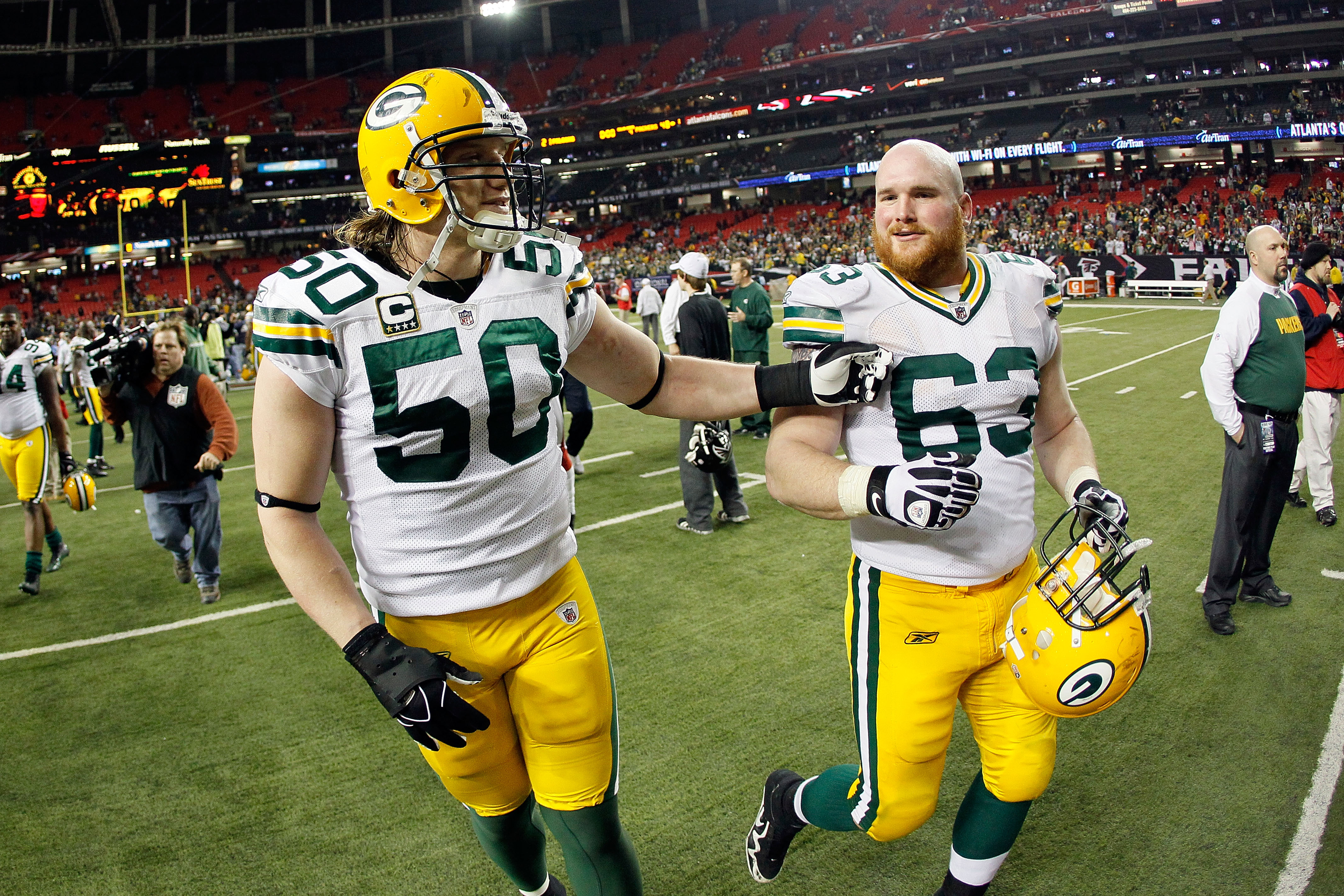 ATLANTA, GA - JANUARY 15:  A.J. Hawk #50 and Scott Wells #63 of the Green Bay Packers celebrate as they walk off the field after they won 48-21 against the Atlanta Falcons during their 2011 NFC divisional playoff game at Georgia Dome on January 15, 2011 i