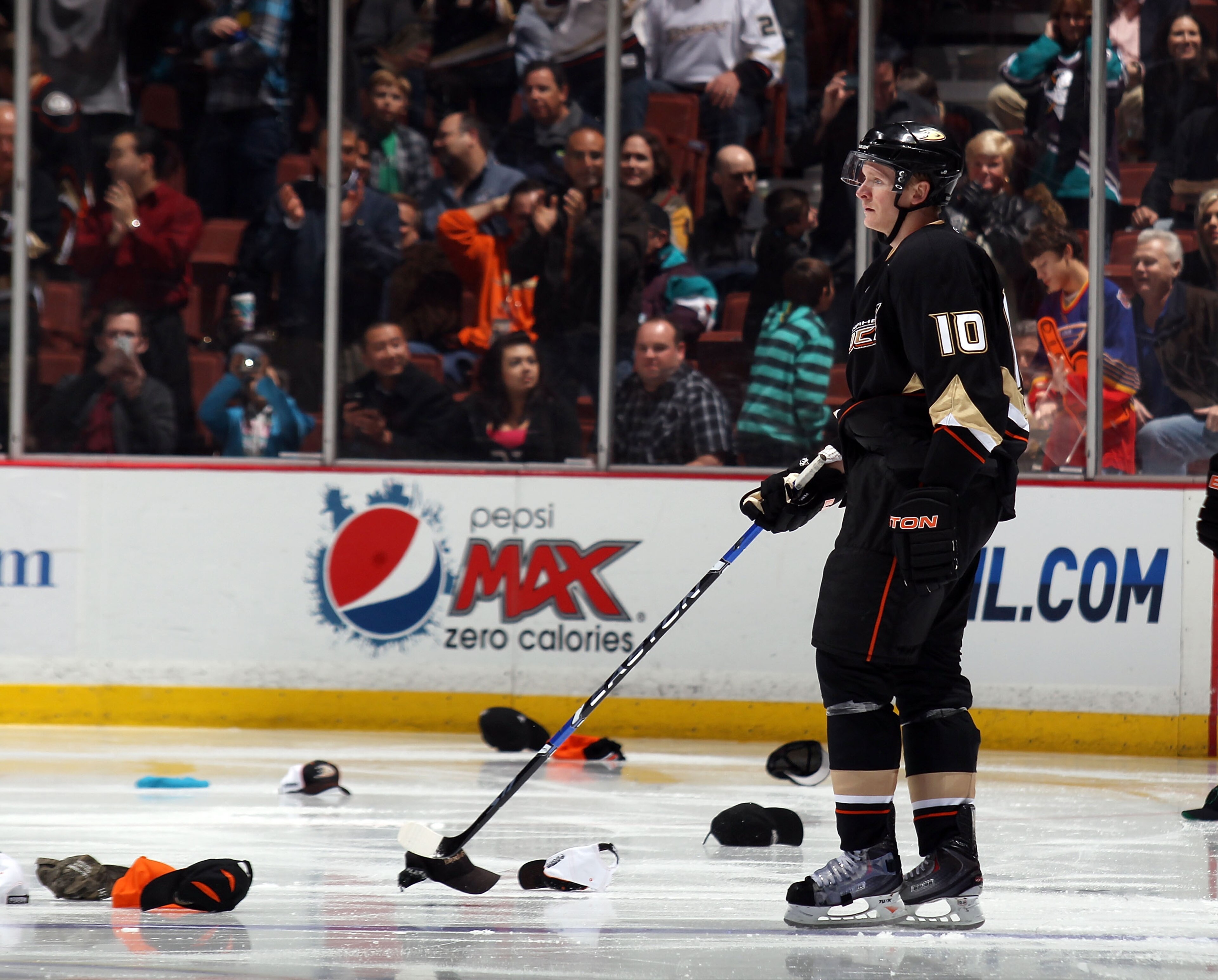 ANAHEIM, CA - JANUARY 12:  Corey Perry #10 of the Anaheim Ducks stands amongst the hats following a hattrick by teammate Bobby Ryan #9 (not shown) against the St. Louis Blues at the Honda Center on January 12, 2011 in Anaheim, California. The Ducks defeat