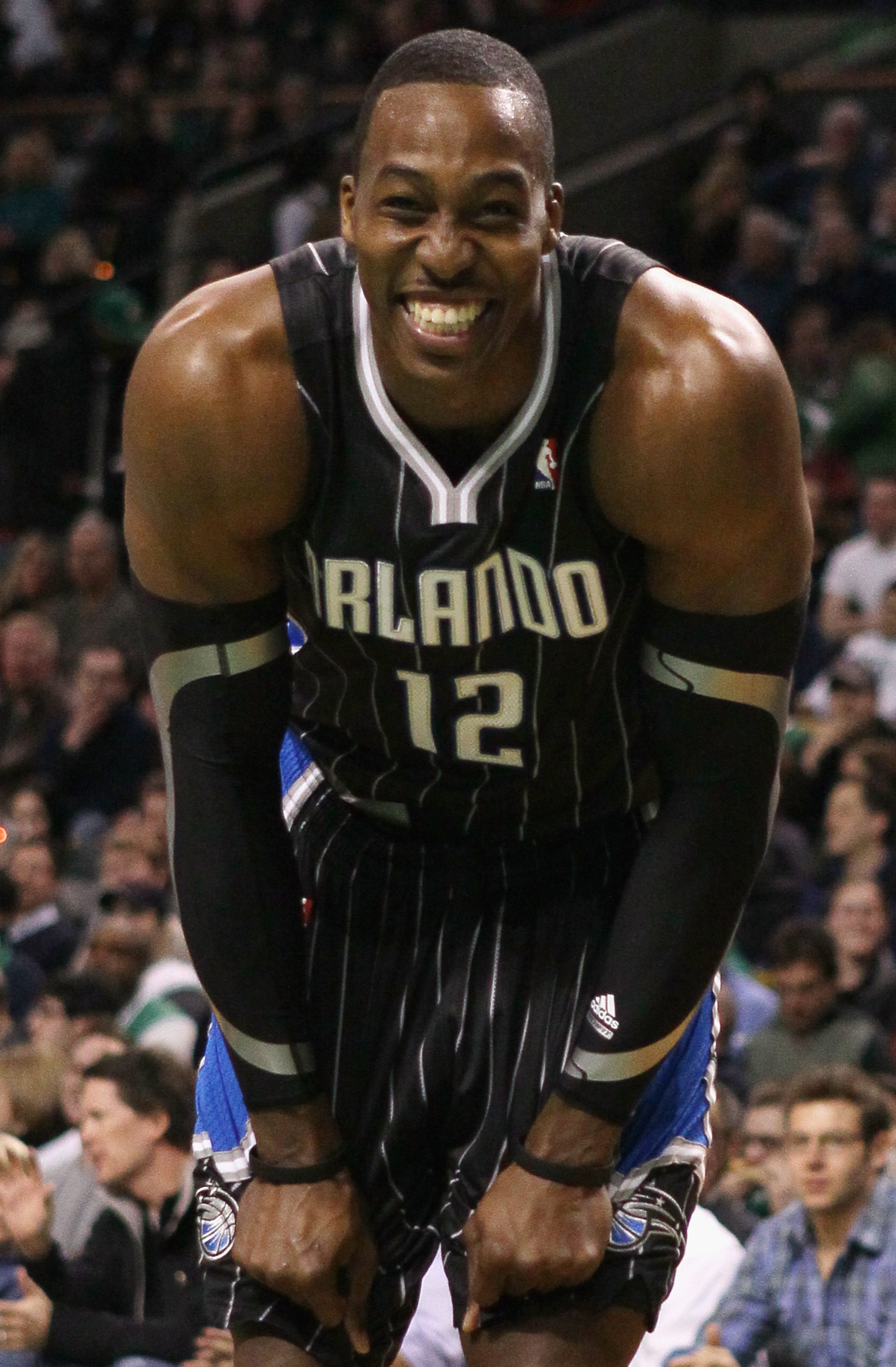 BOSTON, MA - JANUARY 17: Dwight Howard #12 of the Orlando Magic smiles on the baseline as he waits for Shaquille O'Neal of the Boston Celtics to shoot a free throw on January 17, 2011 at the TD Garden in Boston, Massachusetts. NOTE TO USER: User express BOSTON, MA - JANUARY 17: Dwight Howard #12 of the Orlando Magic smiles on the baseline as he waits for Shaquille O'Neal of the Boston Celtics to shoot a free throw on January 17, 2011 at the TD Garden in Boston, Massachusetts. NOTE TO USER: User express