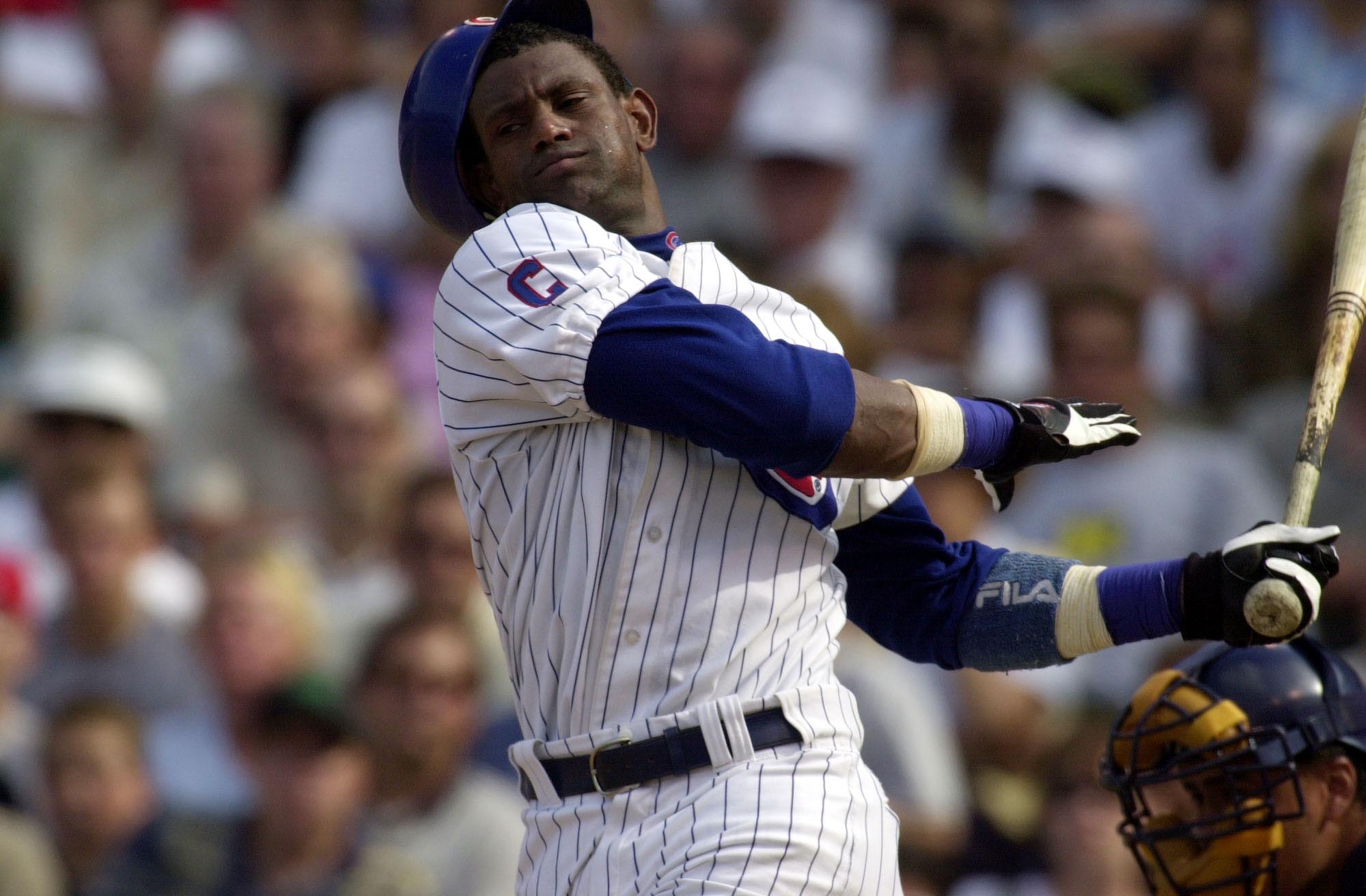23 Aug 2001:  Outfielder Sammy Sosa #21 of the Chicago Cubs swings at a pitch so hard that he loses his batting helmet in the seventh inning of a game against the Milwaukee Brewers at Wrigley Field in Chicago, Illinois. The Brewers won 8-1. DIGITAL IMAGE