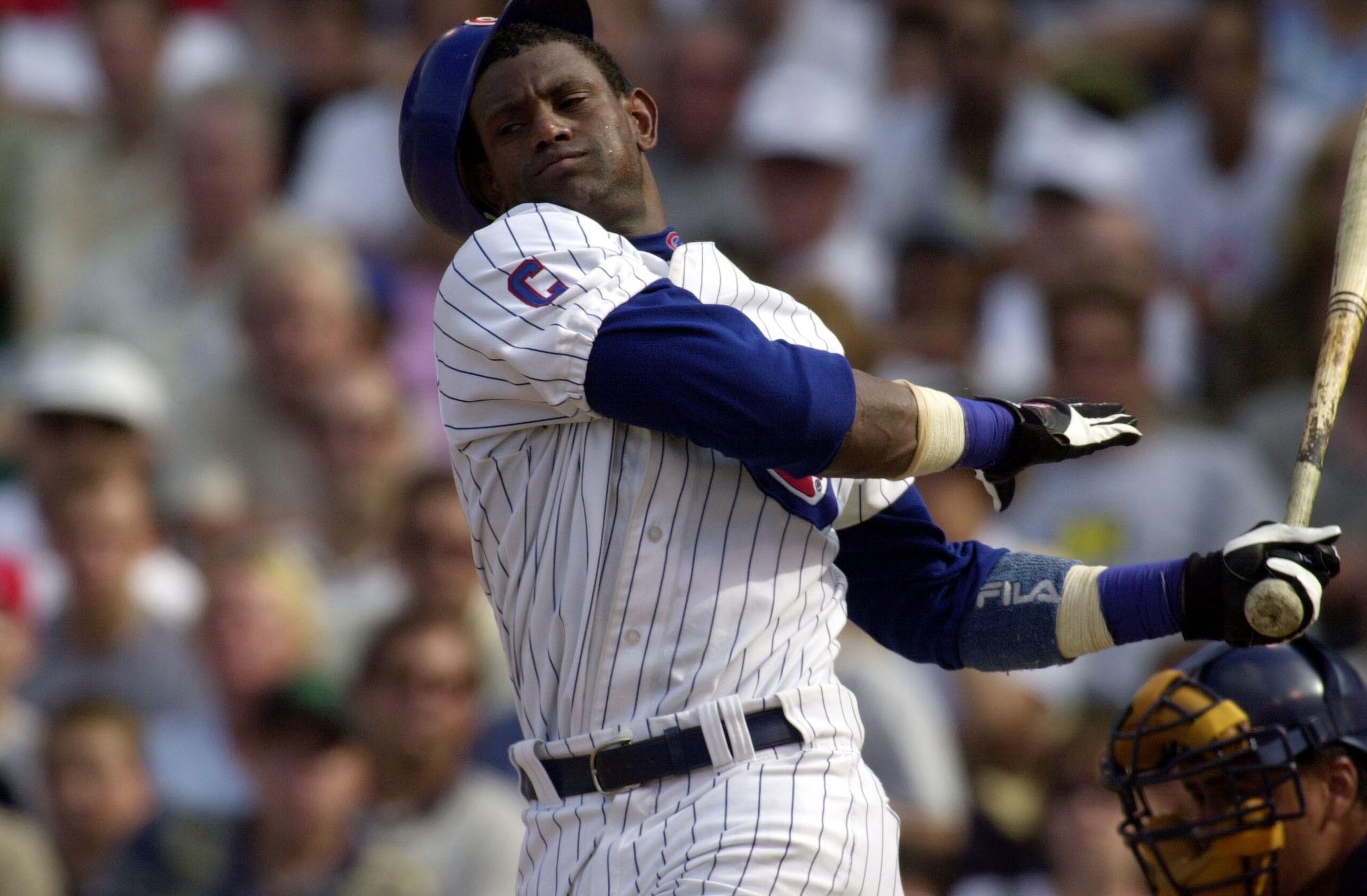 23 Aug 2001:  Outfielder Sammy Sosa #21 of the Chicago Cubs swings at a pitch so hard that he loses his batting helmet in the seventh inning of a game against the Milwaukee Brewers at Wrigley Field in Chicago, Illinois. The Brewers won 8-1. DIGITAL IMAGE