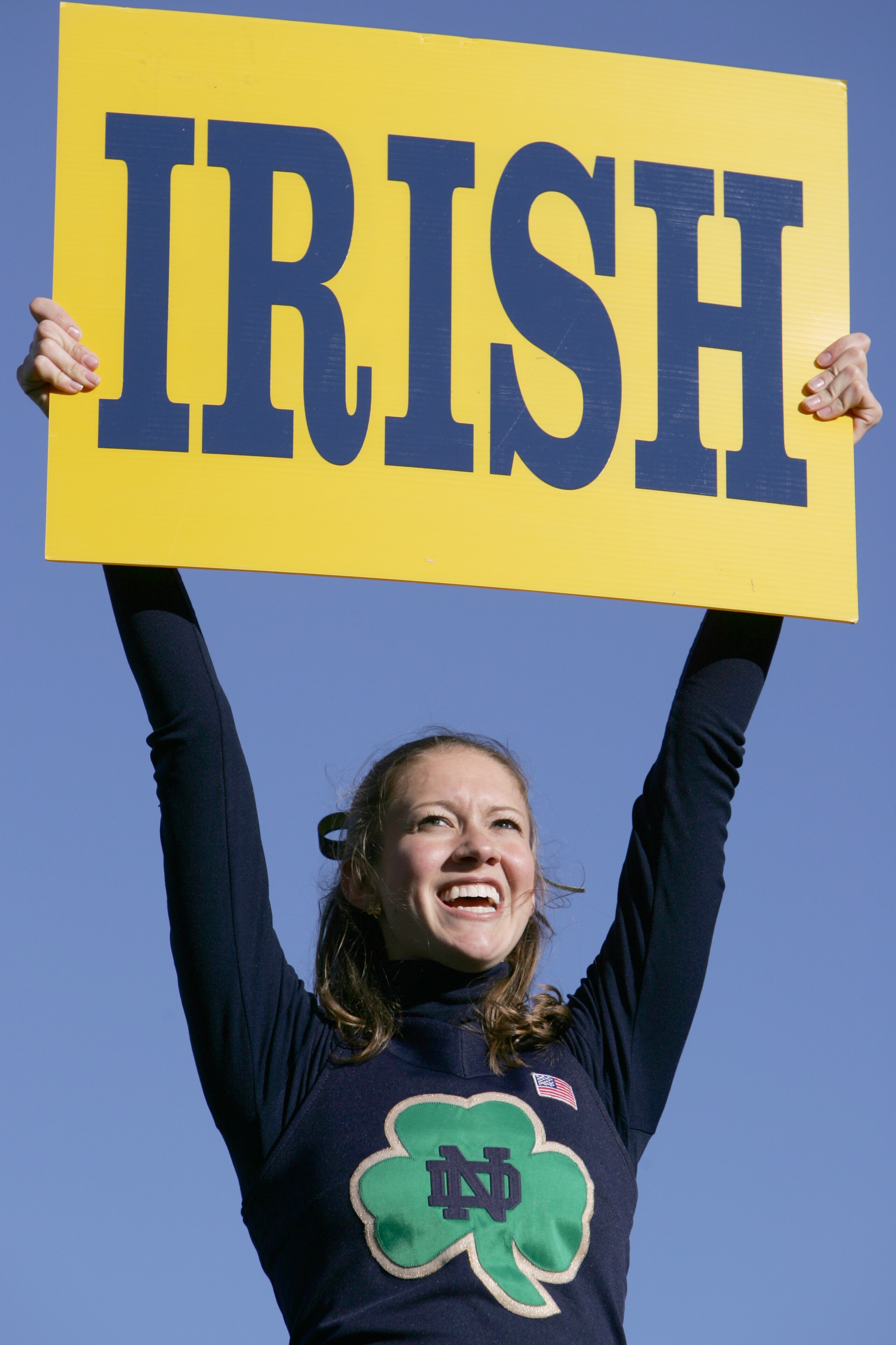 SOUTH BEND, IN - OCTOBER 15:  An University of Notre Dame Fighting Irish cheerleader holds an 'Irish' sign during the game against the University of Southern California Trojans on October 15, 2005 at Notre Dame Stadium in South Bend, Indiana. USC defeated