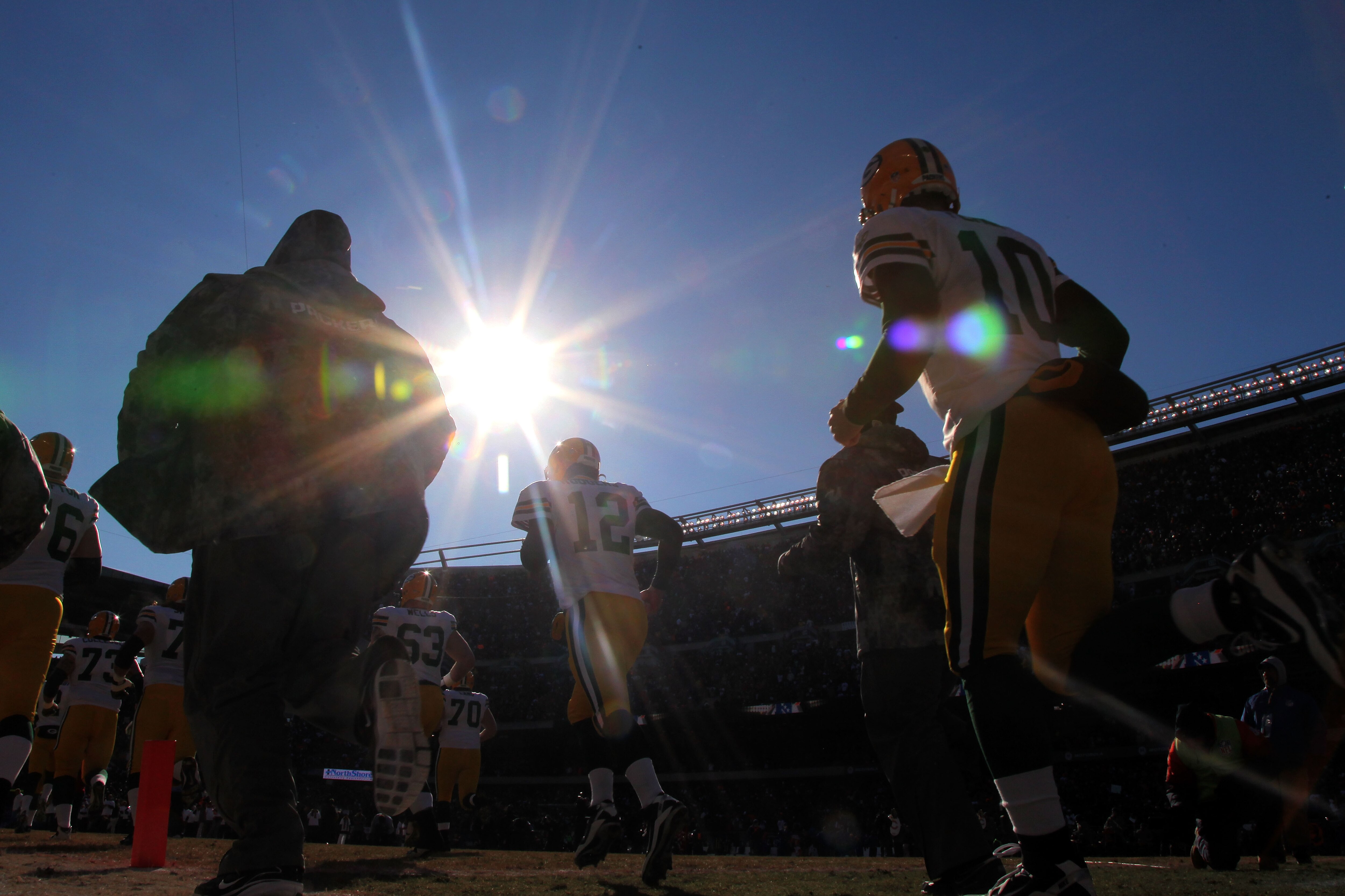 CHICAGO, IL - JANUARY 23:  Aaron Rodgers #12 and Matt Flynn #10 of the Green Bay Packers runs out of the tunnel to take on the Chicago Bears in the NFC Championship Game at Soldier Field on January 23, 2011 in Chicago, Illinois.  (Photo by Doug Pensinger/