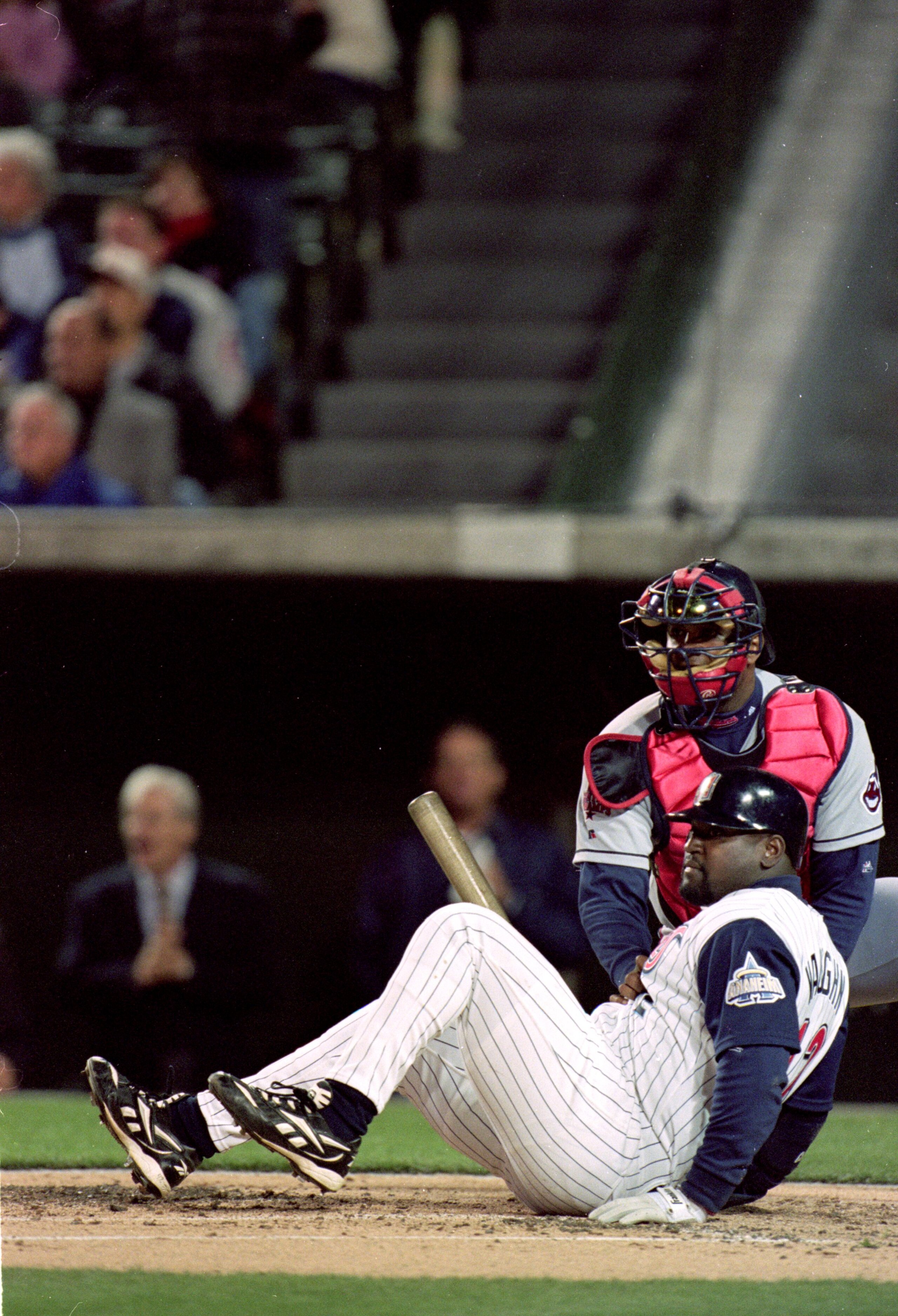 6 Apr 1999:  Mo Vaughn #42 of the Anaheim Angels falls over after hitting a fly ball out at his first at bat as he is held by Catcher Sandy Alomar #15 of the Cleveland Indians at the Edison Field in Anaheim, California. The Angels defeated the Indians 6-5