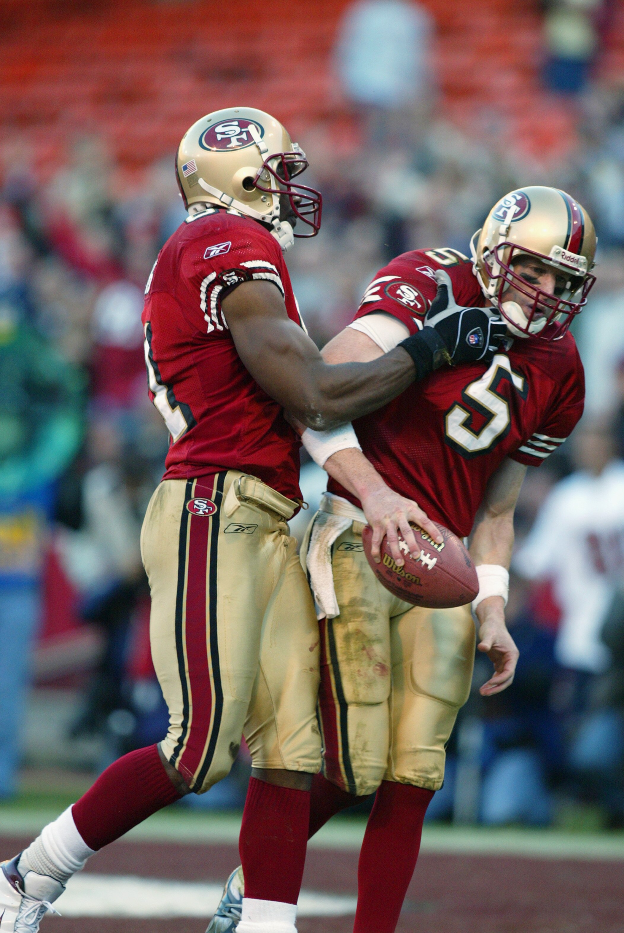 SAN FRANCISCO - JANUARY 5:  Quarterback Jeff Garcia #5 of the San Fransisco 49ers is congratulated by teammate Terrell Owens #81 after Garcia ran for a touchdown against the New York Giants during the NFC Wild Card game at 3Com Park on January 5, 2003 in