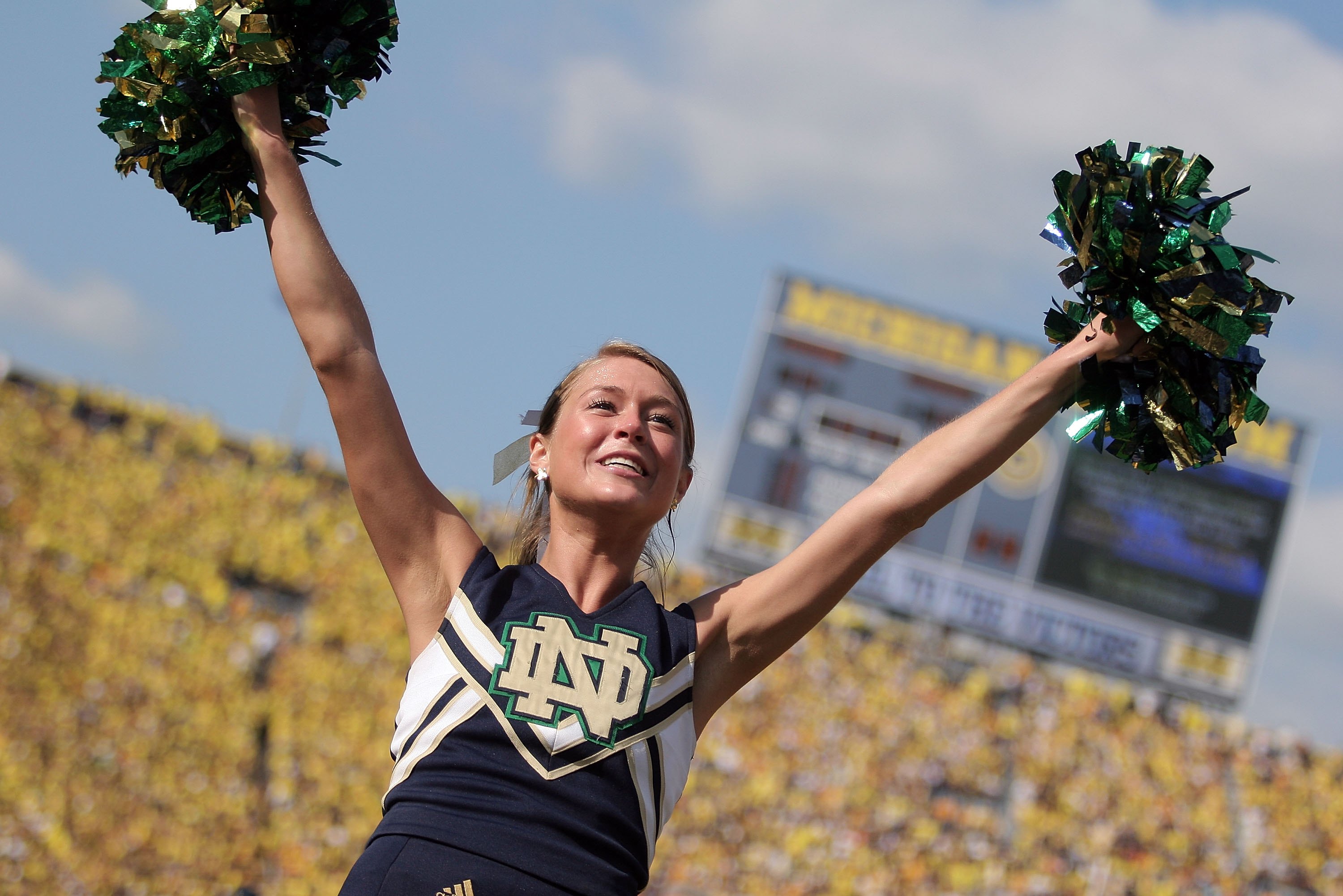 ANN ARBOR, MI - SEPTEMBER 12:  A Notre Dame cheerleader cheers on the visiting crowd against Michigan at Michigan Stadium on September 12, 2009 in Ann Arbor, Michigan.  (Photo by Domenic Centofanti/Getty Images)