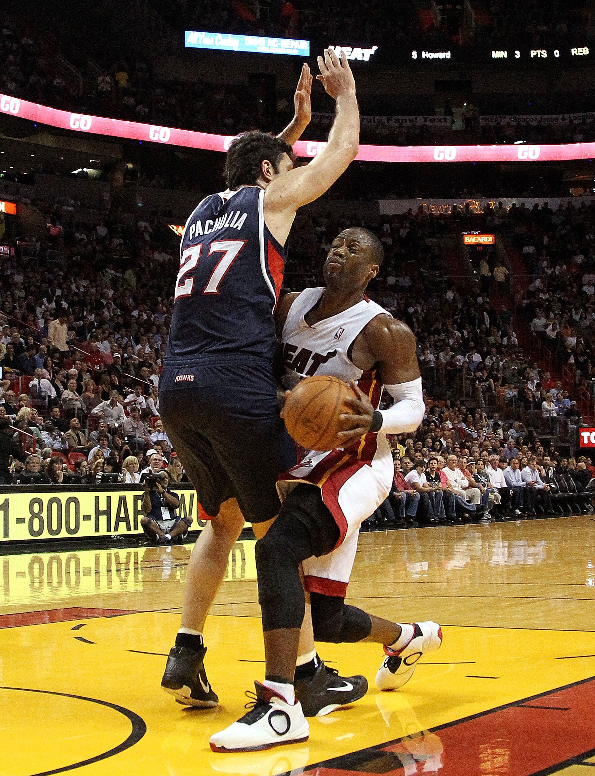 MIAMI, FL - JANUARY 18:  Dwyane Wade #3 of the Miami Heat drives against Zaza Pachulia #27 of the Atlanta Hawks  during a game at American Airlines Arena on January 18, 2011 in Miami, Florida. NOTE TO USER: User expressly acknowledges and agrees that, by