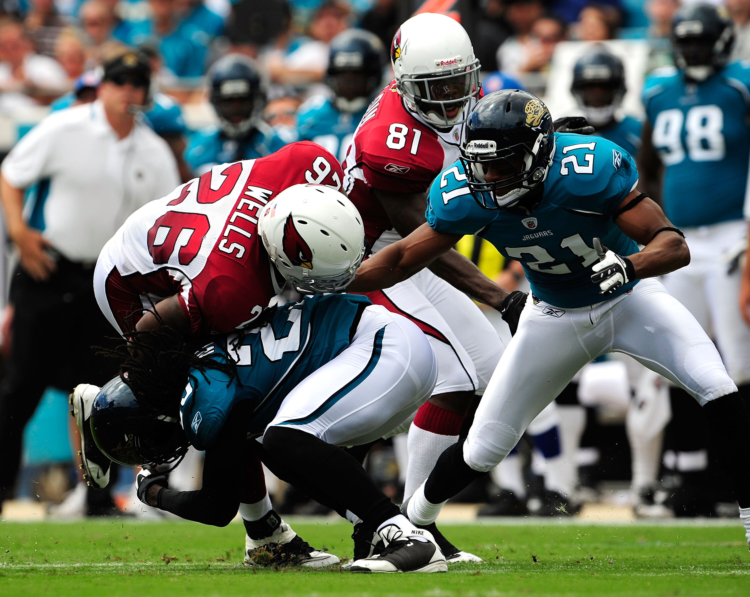 JACKSONVILLE, FL - SEPTEMBER 20:  Beanie Wells #26 is tackked by Reggie Nelson #25 of the Jacksonville Jaguars during the game at Jacksonville Municipal Stadium on September 20, 2009 in Jacksonville, Florida.  (Photo by Sam Greenwood/Getty Images)