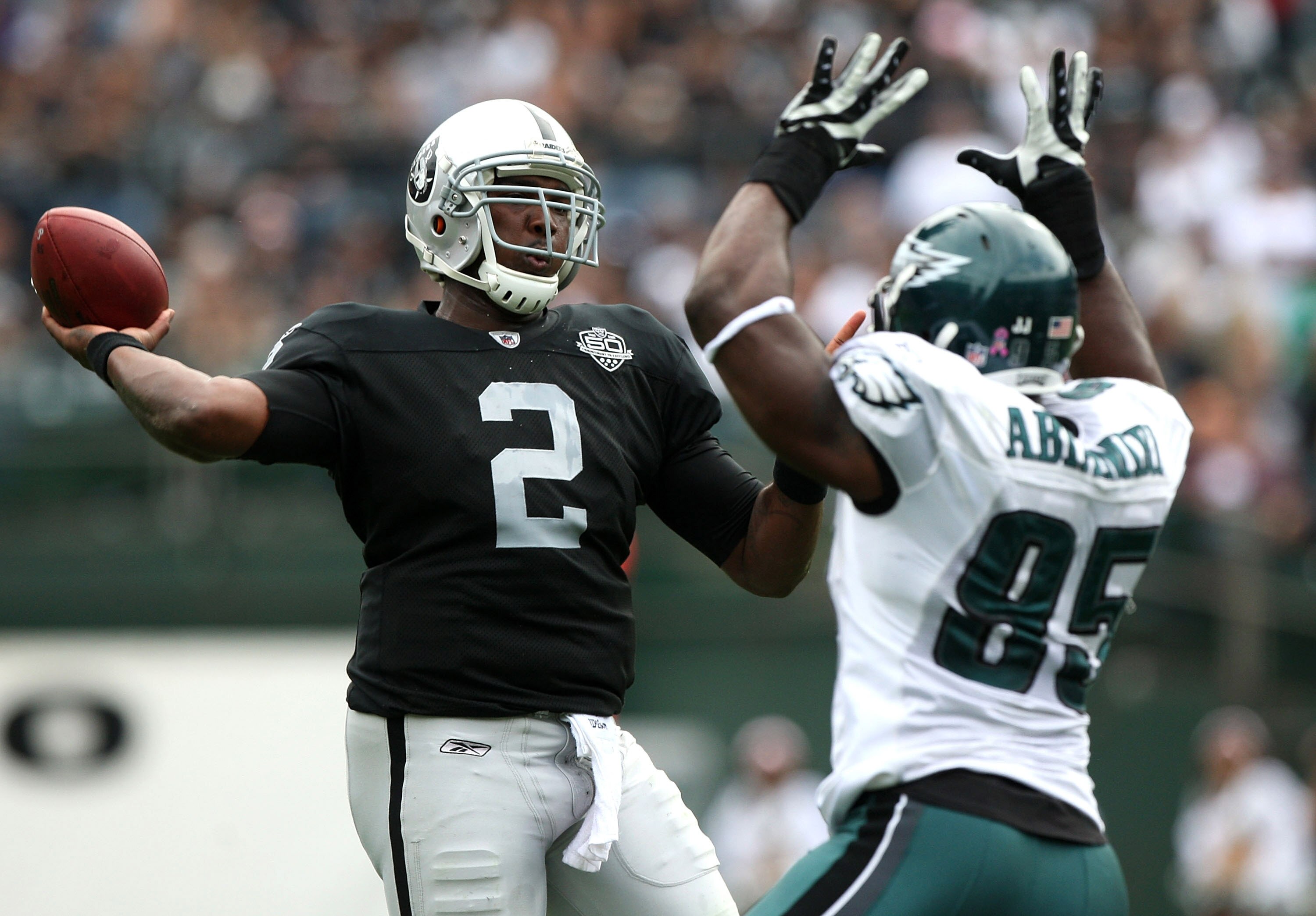 OAKLAND, CA - OCTOBER 18:   JaMarcus Russell #2 of the Oakland Raiders passes against Victor Abiamiri #95 of the Philadelphia Eagles during an NFL game at the Oakland-Alameda County Coliseum on October 18, 2009 in Oakland, California. (Photo by Jed Jacobs