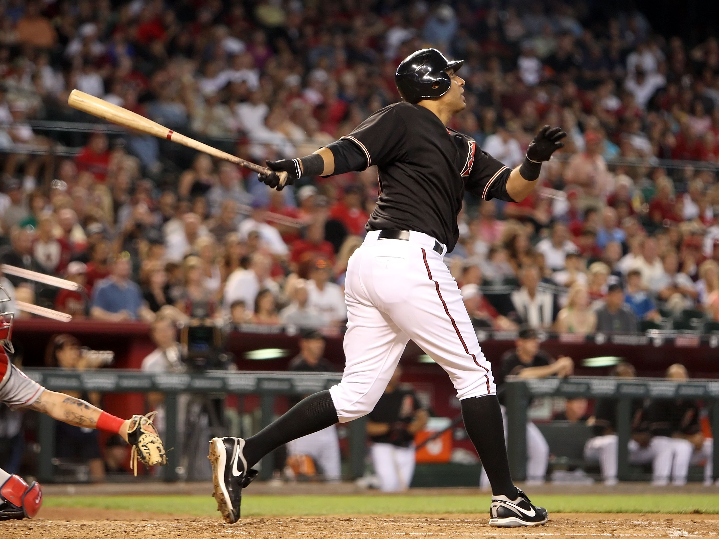 PHOENIX - JUNE 27:  Tony Clark #31 of the Arizona Diamondbacks hits a RBI sacrafice fly against the Los Angeles Angels of Anaheim during the fourth inning of the major league baseball game at Chase Field on June 27, 2009 in Phoenix, Arizona.  (Photo by Ch