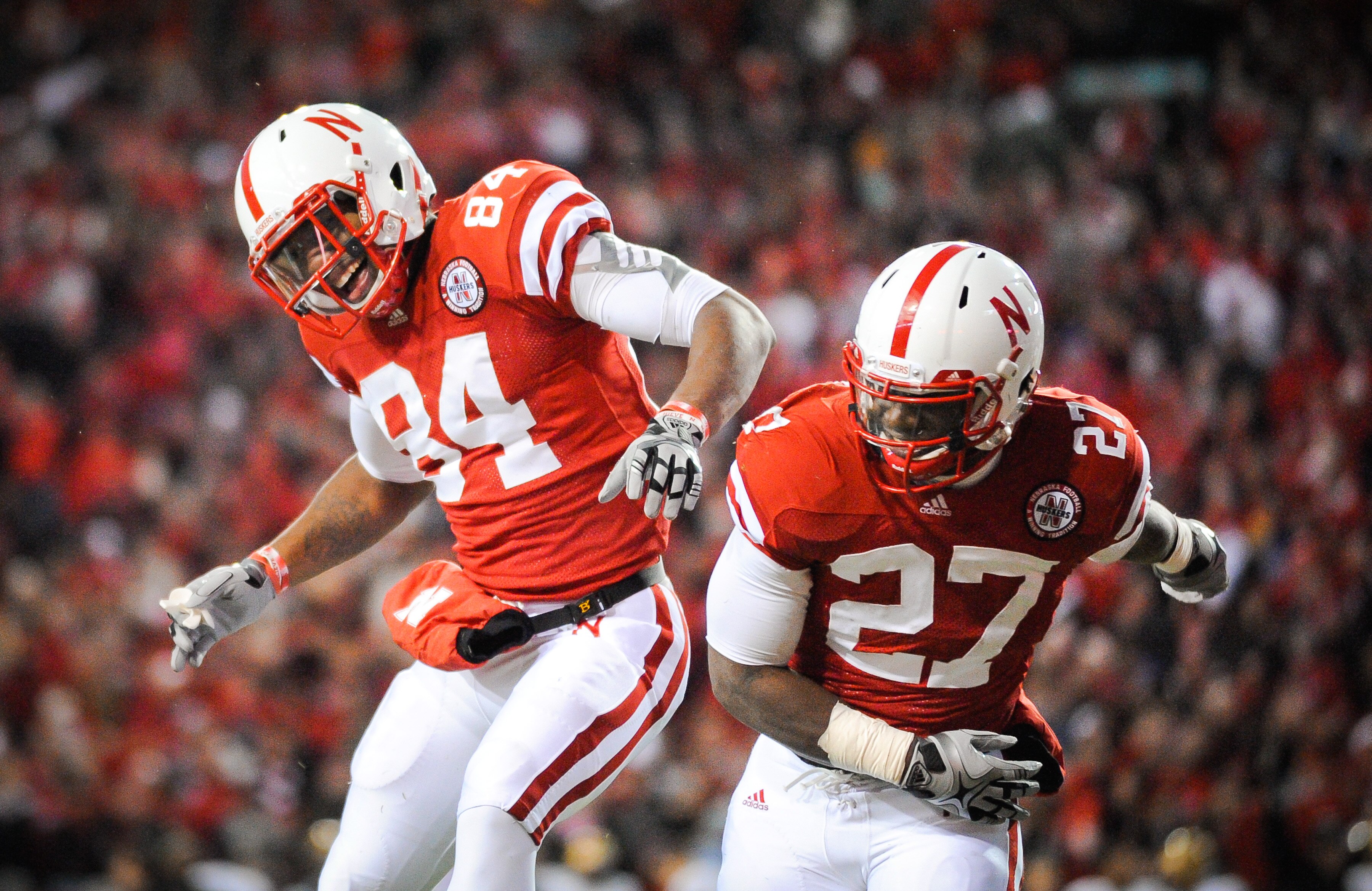 LINCOLN, NE - NOVEMBER 26: Dontrayevous Robinson #27 and Brandon Kinnie #84 of the Nebraska Cornhuskers celebrate a touchdown during their game against the Colorado Buffaloes at Memorial Stadium on November 26, 2010 in Lincoln, Nebraska. Nebraska defeated