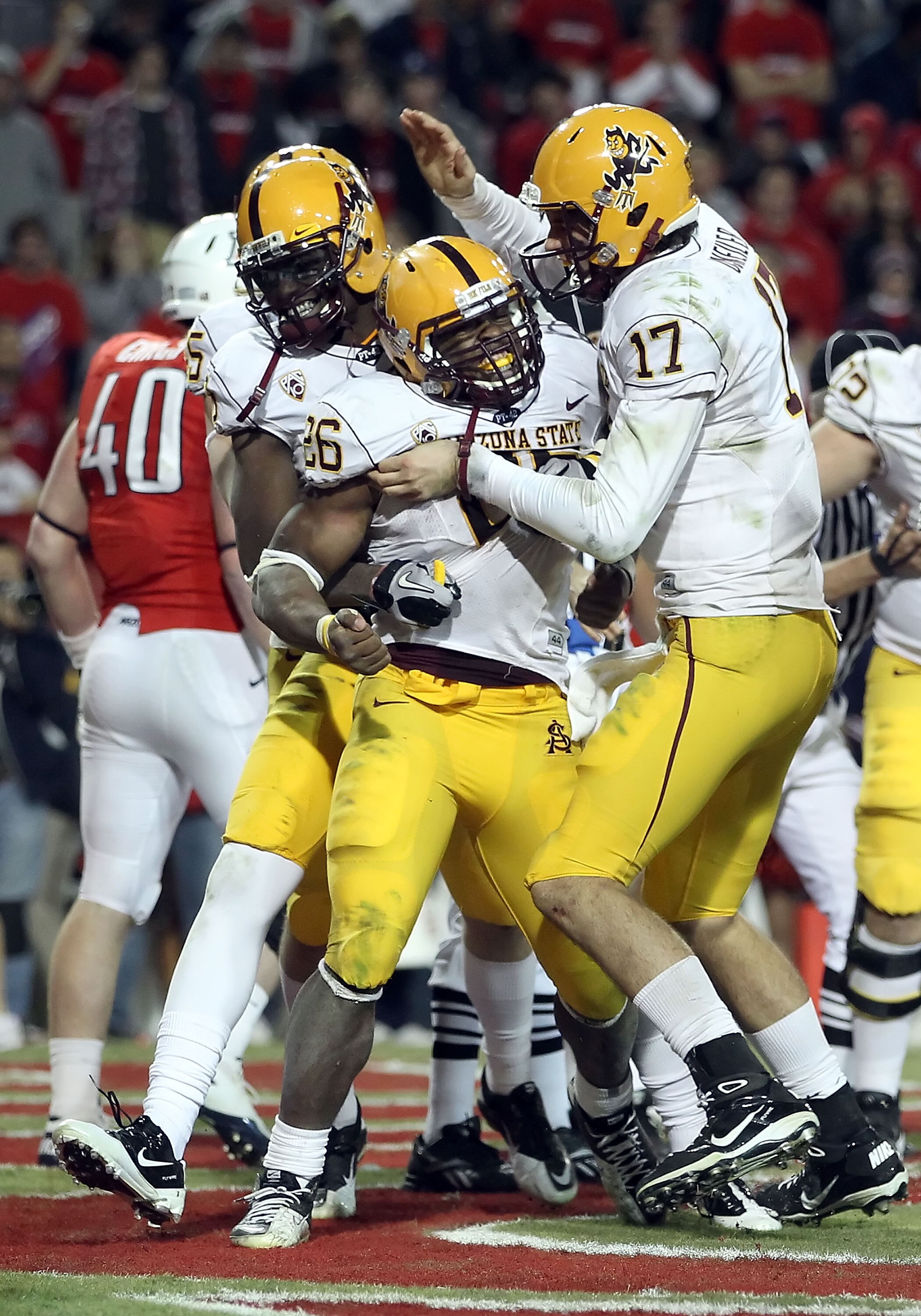 TUCSON, AZ - DECEMBER 02:  Quarterback Brock Osweiler #17 of the Arizona State Sun Devils celebrates with Cameron Marshall #26 after he scored a rushing touchdown against the Arizona Wildcats during the double overtime of the college football game at Ariz