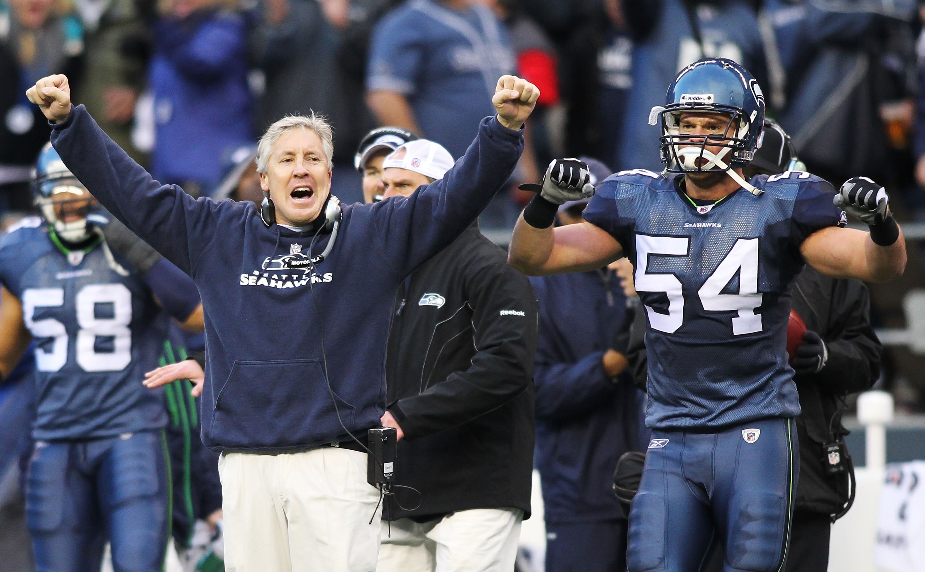 SEATTLE, WA - JANUARY 08: Head coach Pete Carroll and Will Herring #54 of the Seattle Seahawks celebrate a fourth down stop by the Seahawks in the third quarter against the New Orleans Saints during the 2011 NFC wild-card playoff game at Qwest Field on Ja