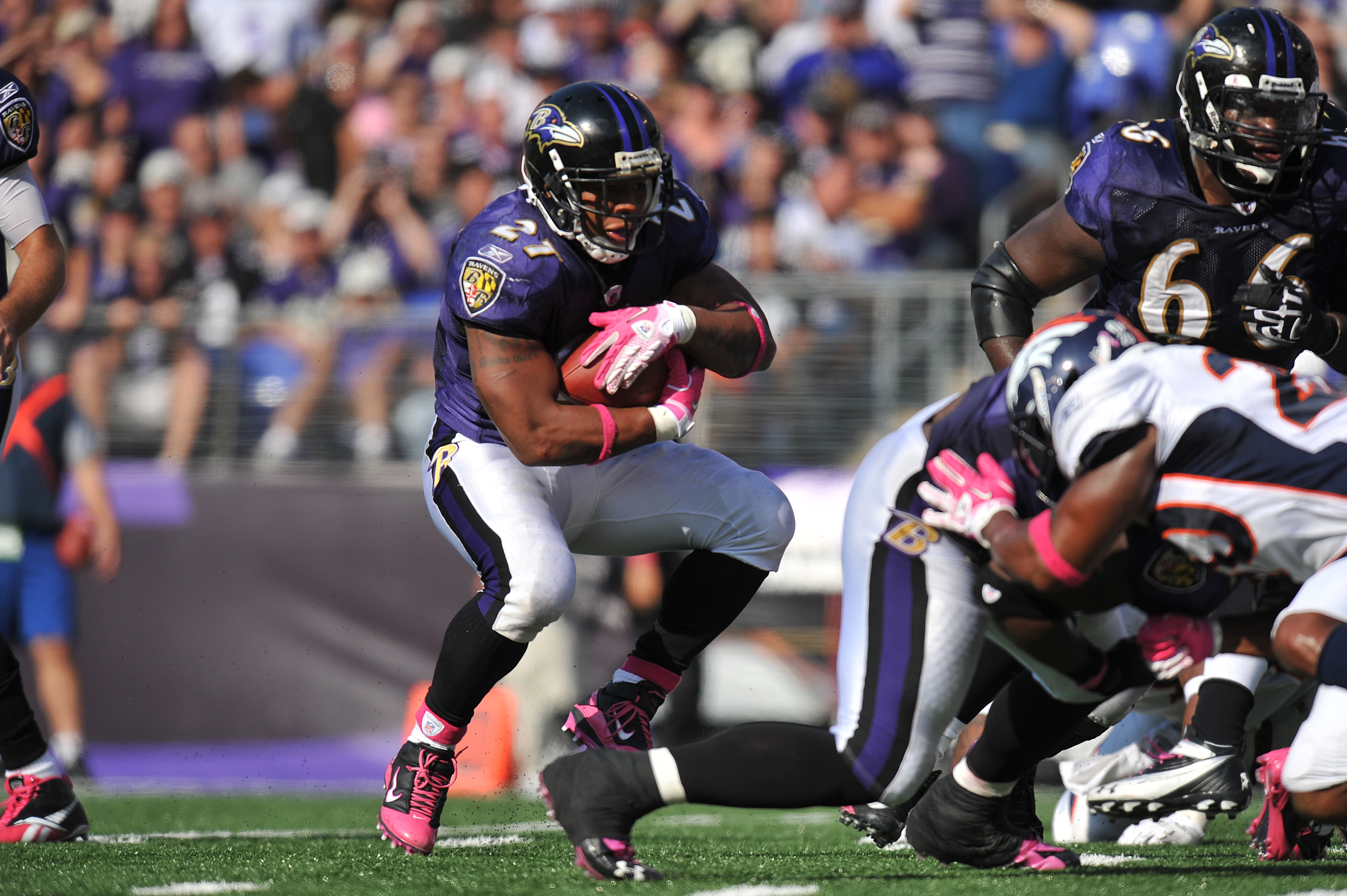 BALTIMORE, MD - OCTOBER 10: Ray Rice #27 of the Baltimore Ravens runs the ball against the Denver Broncos at M&T Bank Stadium on October 10, 2010 in Baltimore, Maryland. Players wore pink in recognition of Breast Cancer Awareness Month. The Ravens defeate