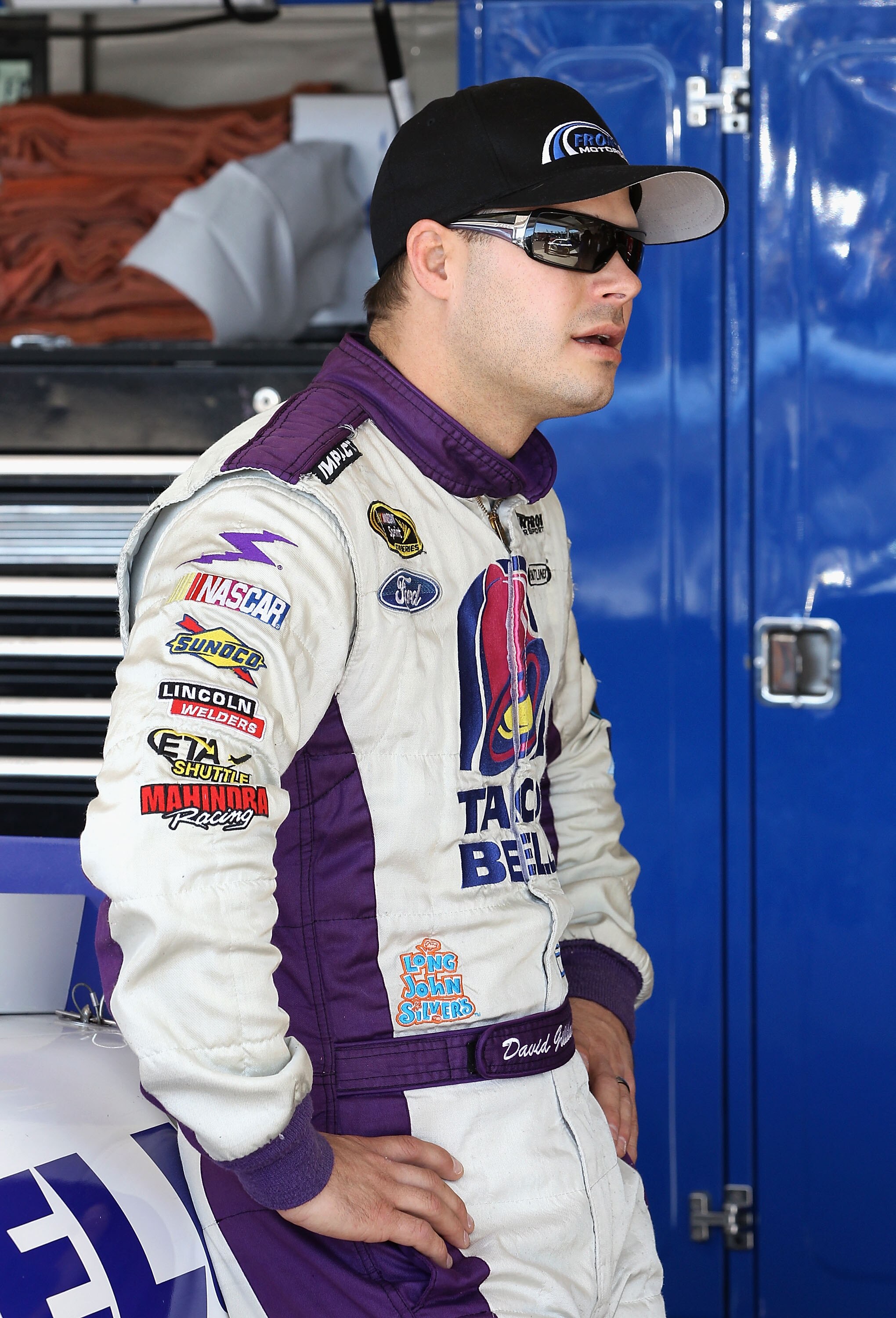 AVONDALE, AZ - NOVEMBER 12:  David Gilliland, driver of the #37 Taco Bell Ford, stands in the garage during practice for the NASCAR Sprint Cup Series Kobalt Tools 500 at Phoenix International Raceway on November 12, 2010 in Avondale, Arizona.  (Photo by C